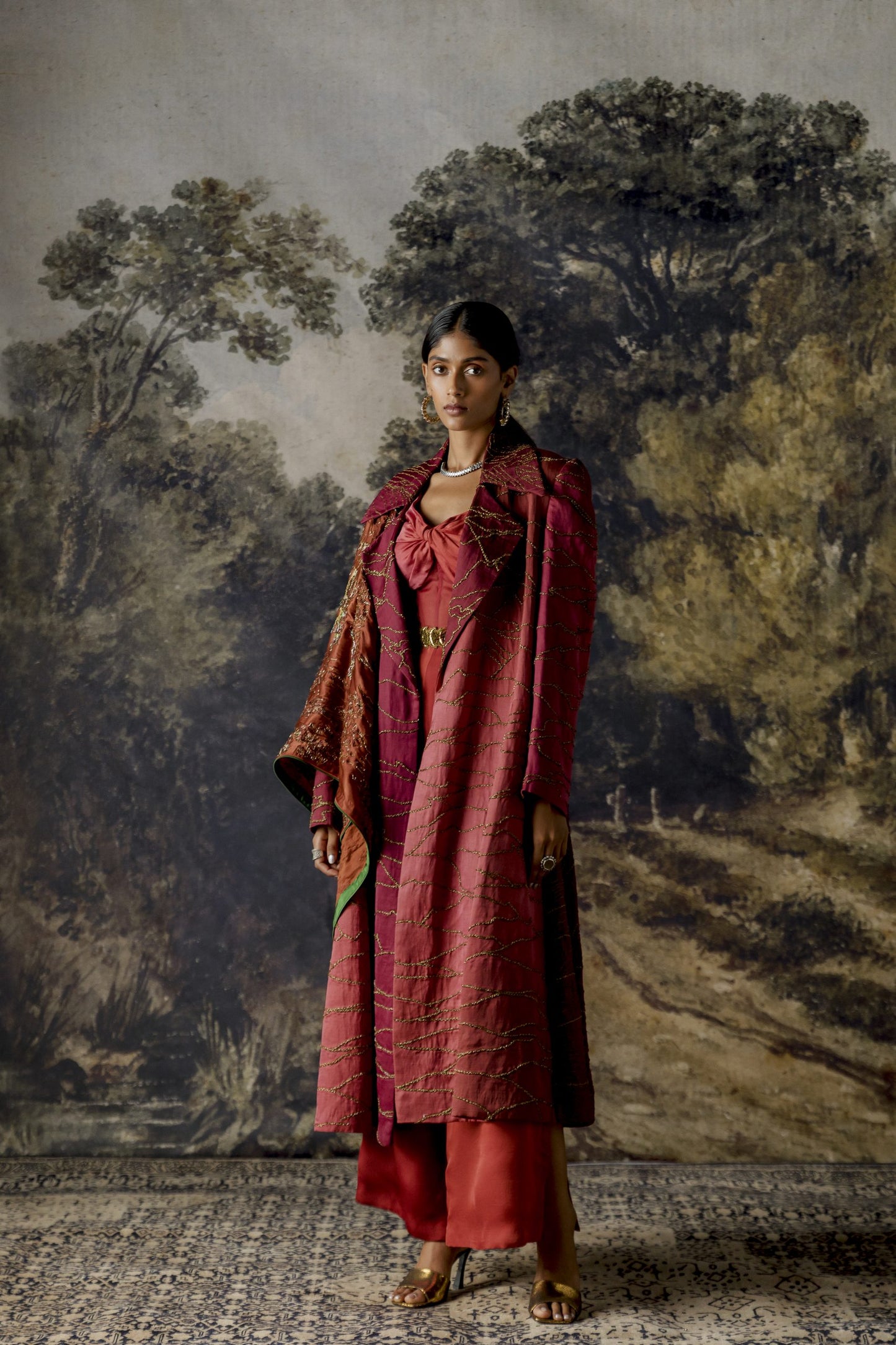 Stylish multi-hued jumpsuit with a jacket featuring antique scrawl embroidery in rose and ruby tones, inspired by landscapes