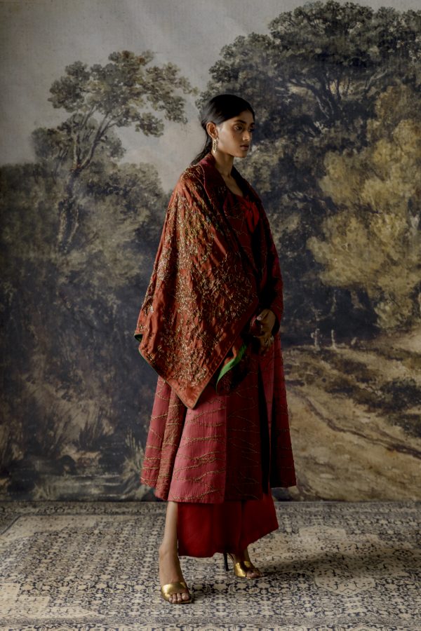 Side view of the jumpsuit with a jacket, emphasizing the silhouette and embroidery details