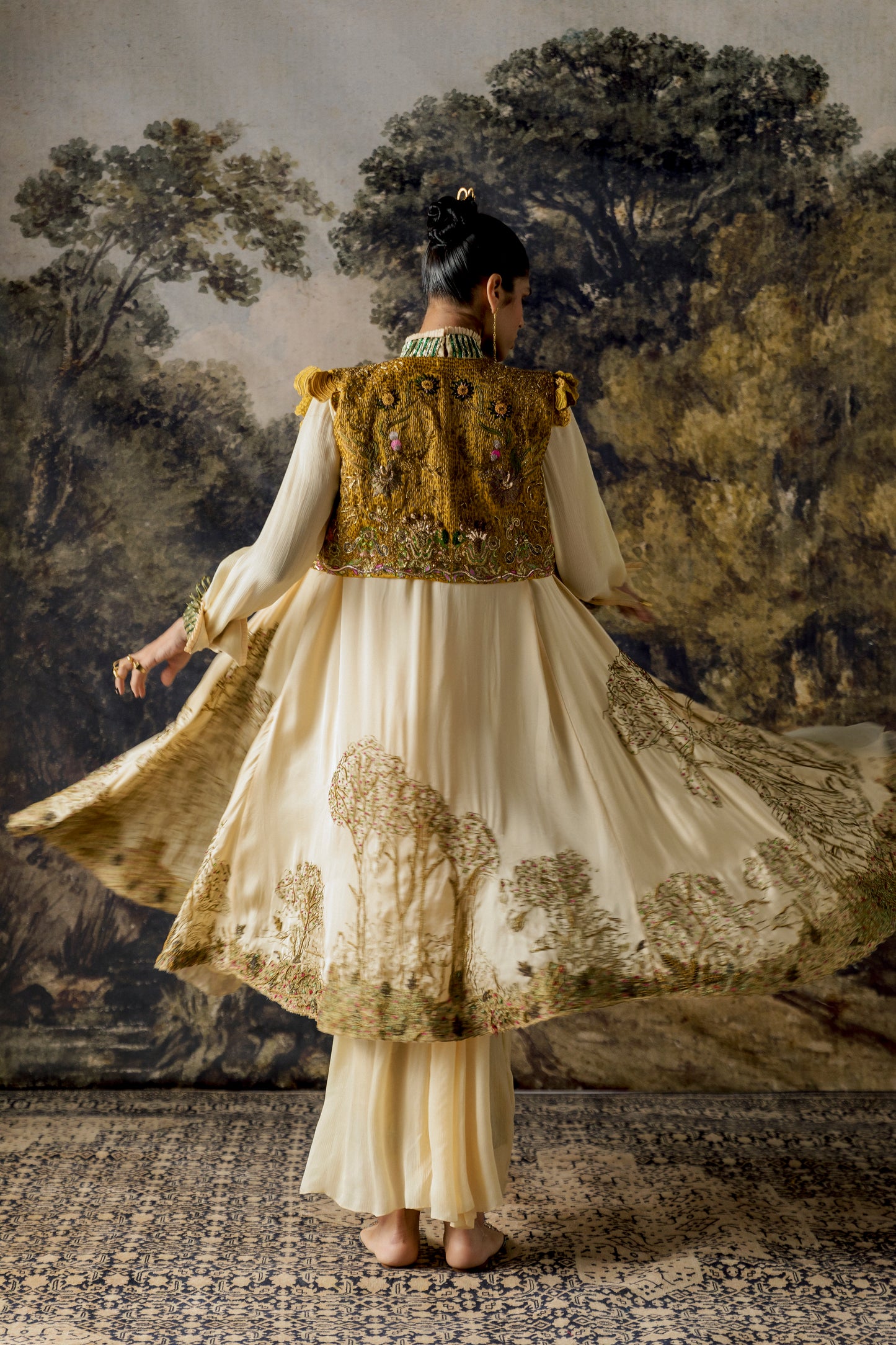 Back view of the Rumi Gown with cape and cropped jacket, emphasizing the gown's fit and cape design