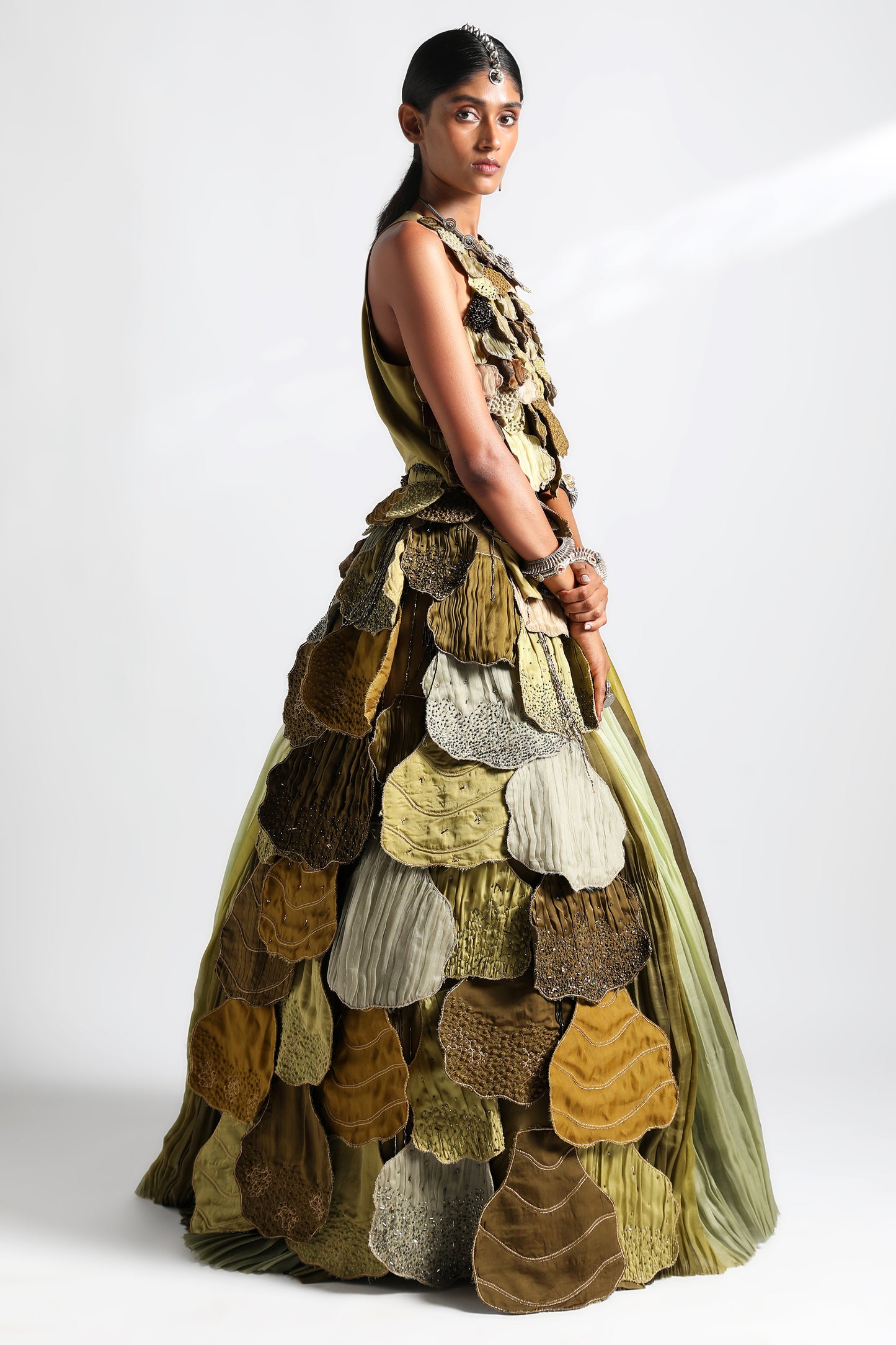 Side view of the lehenga set showcasing the dual-hued pleats and handcrafted leaf belt