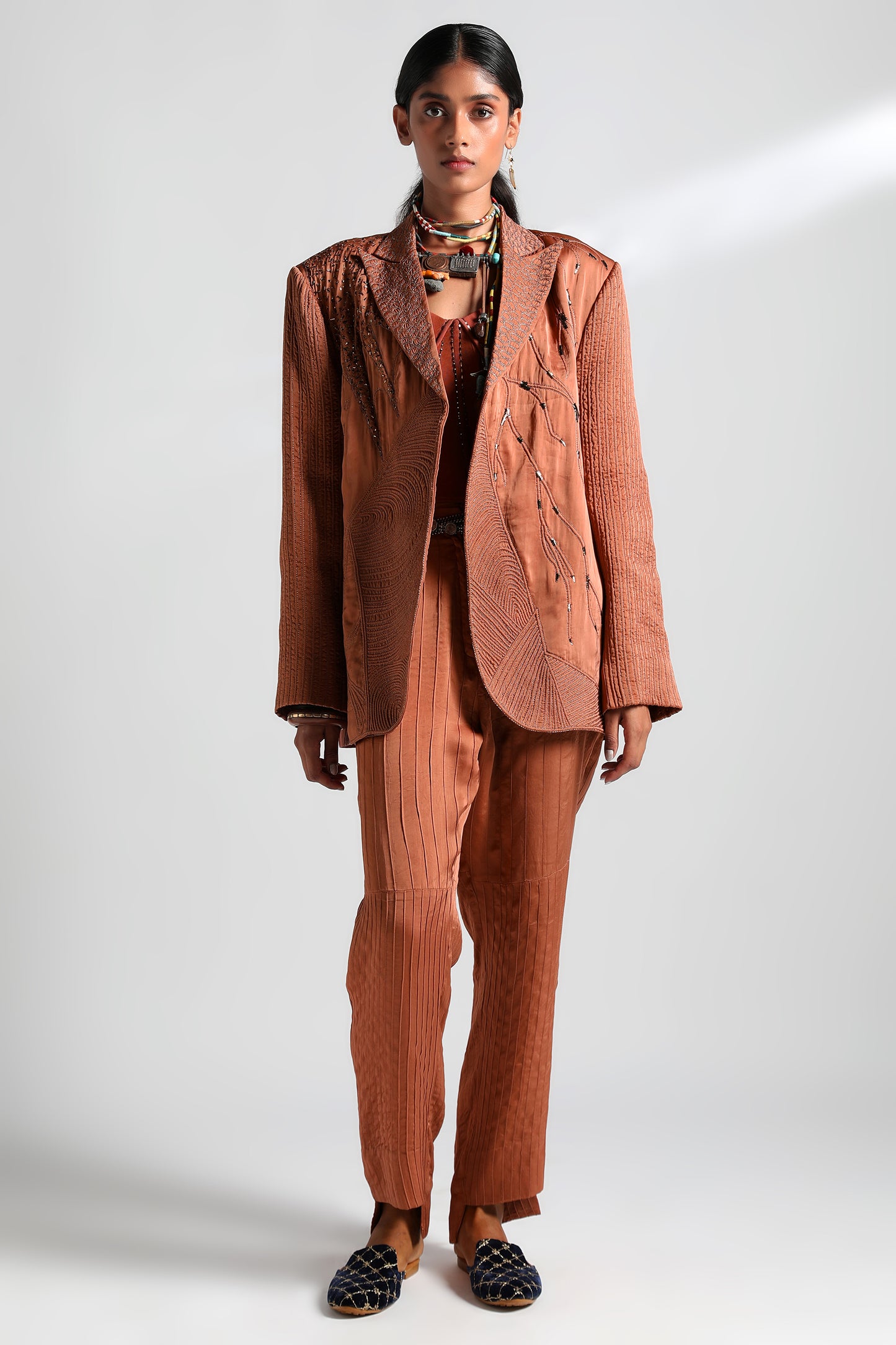 Front view of the pintuck trousers and embroidery on the corset of the Jaisalmer suit set for women