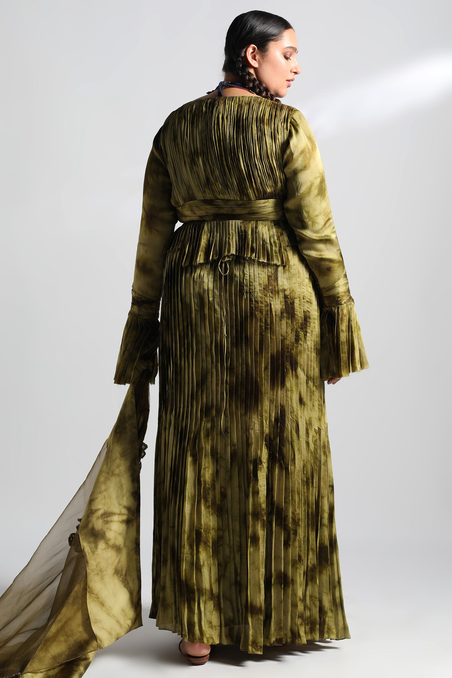 Back view of women’s lehenga set with pleated skirt and ruched blouse