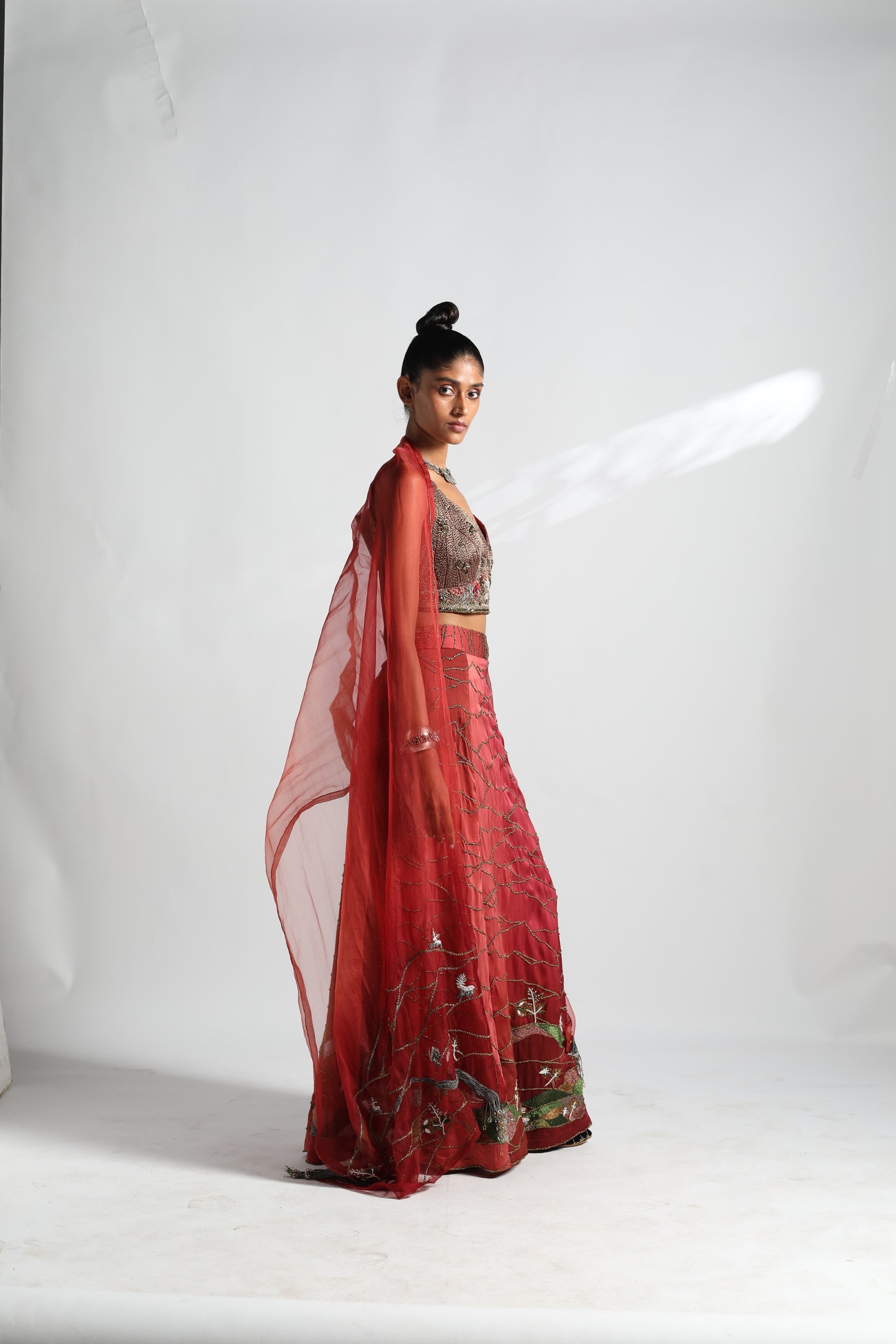Side view of Namib lehenga and dupatta set with metallic blouse and intricate embroidery