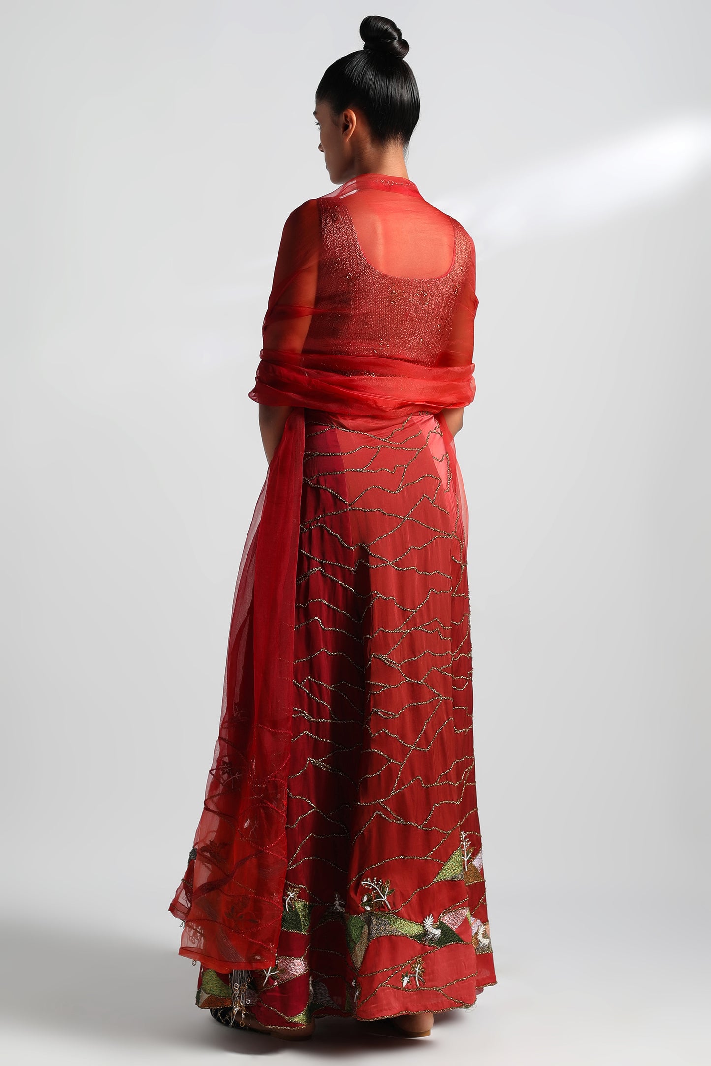Back view of the embroidered lehenga set with corset blouse and organza dupatta
