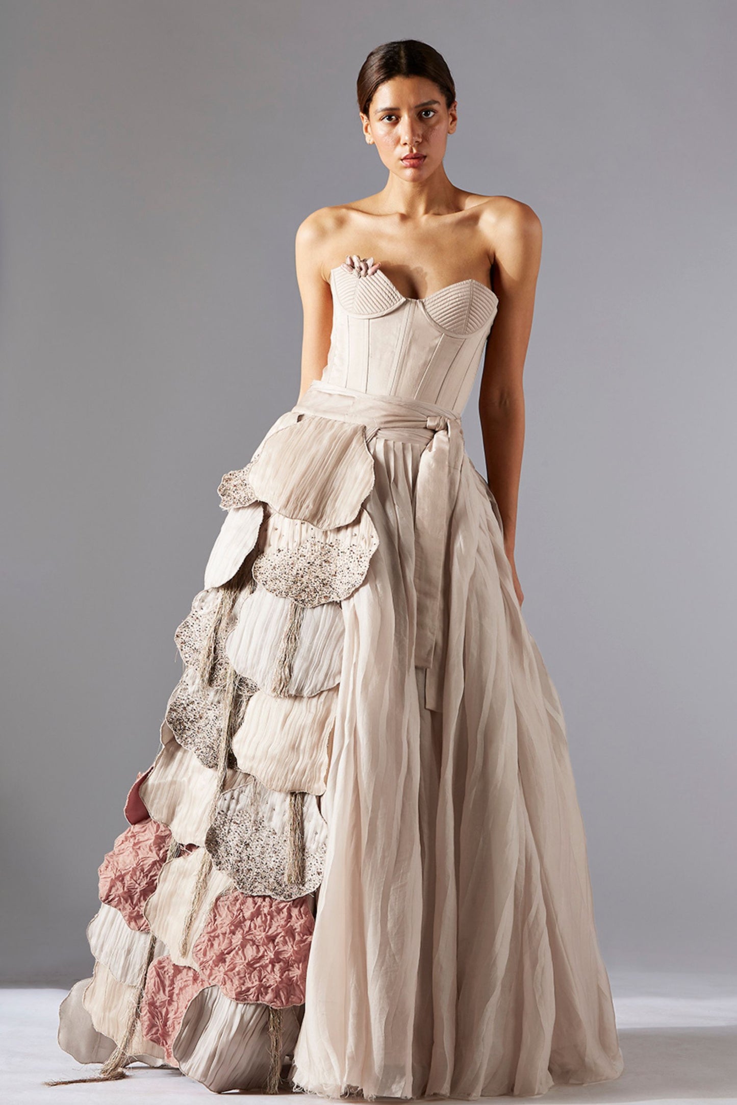 Luxury quilted corset paired with a pleated skirt and fungi-inspired laurel designer belt, offering a chic and sophisticated look for women