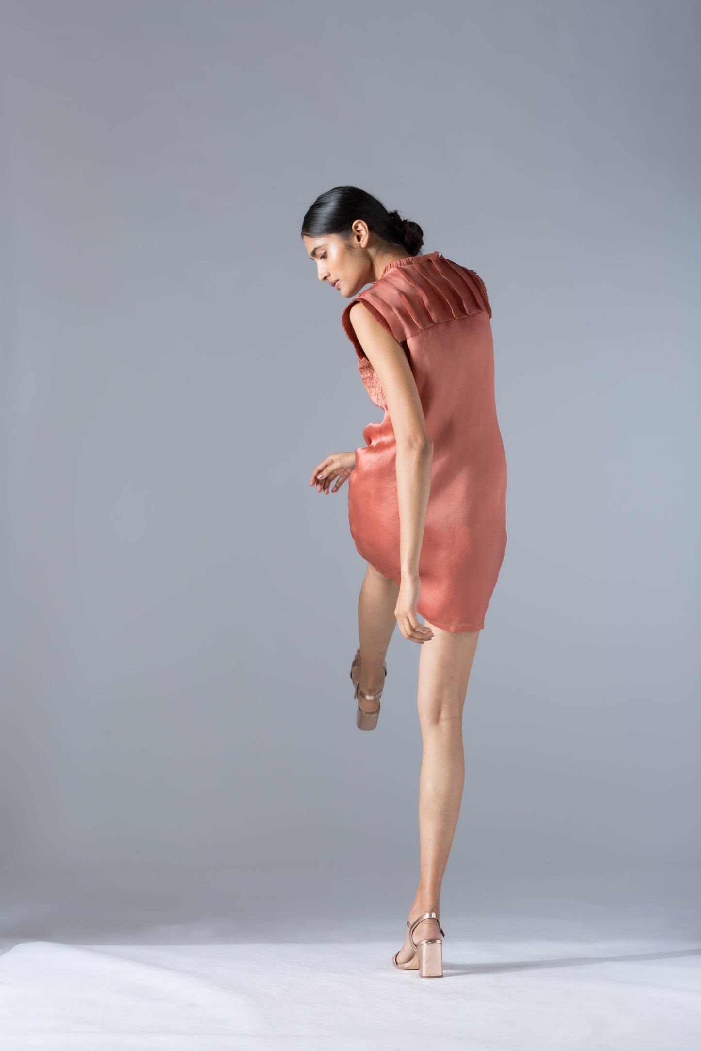 Back view of the luxury dress, highlighting the sleek lines and modern cut with rope detailing