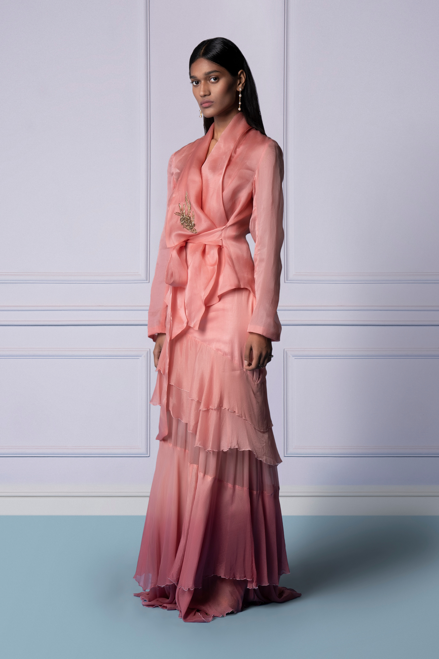 Side view of pink jacket and frill skirt set with metallic detailing