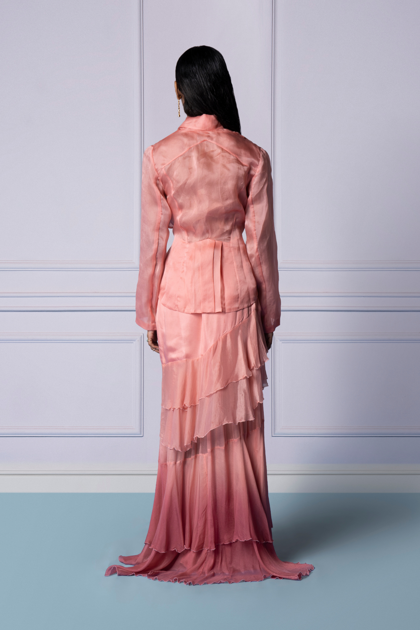 Back view of iconic pink jacket with layered frill skirt