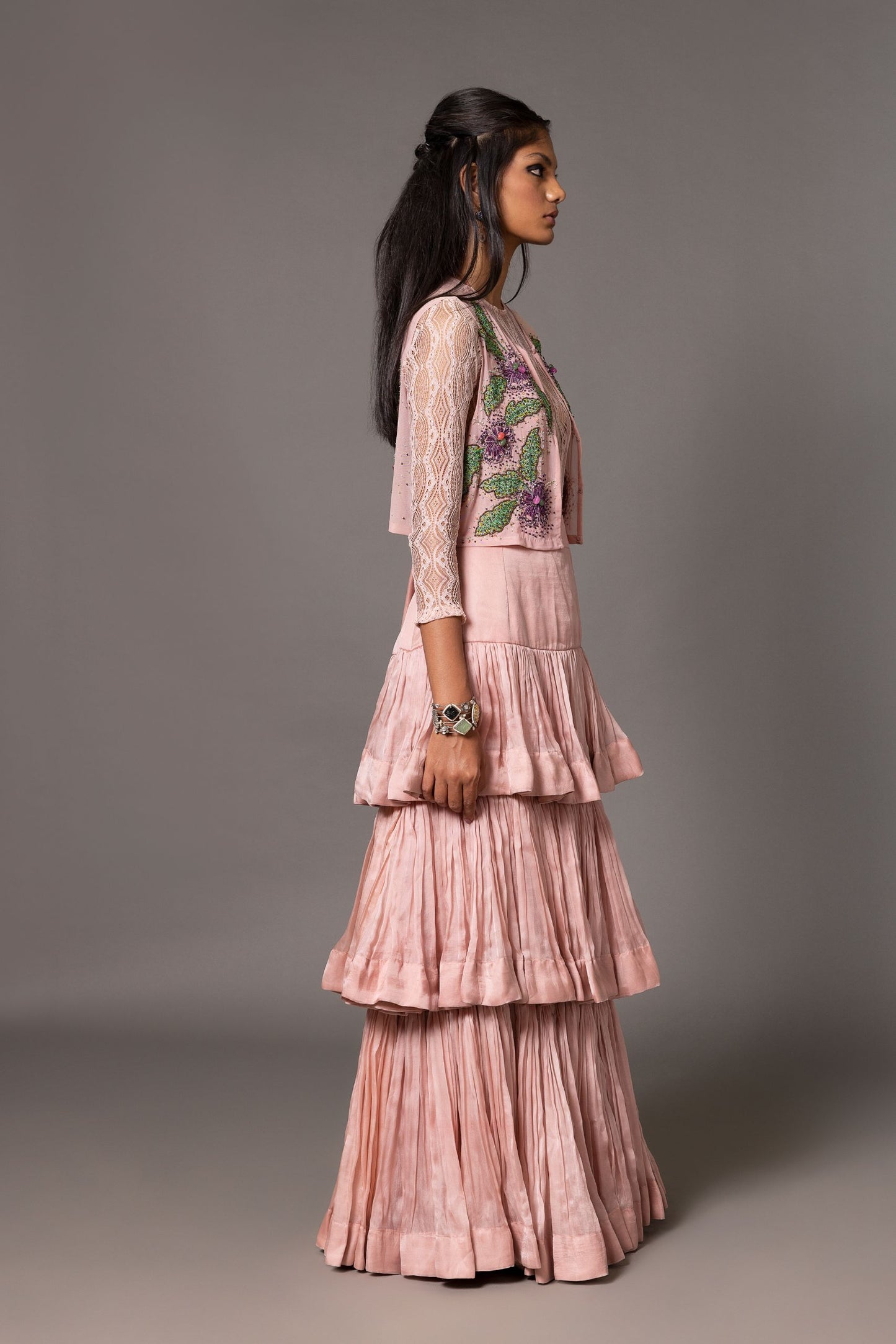 Side view of the Sang-e-Sitara Lehenga Set, showing the silhouette of the embroidered jacket, lace leotard, and flow of the layered skirt