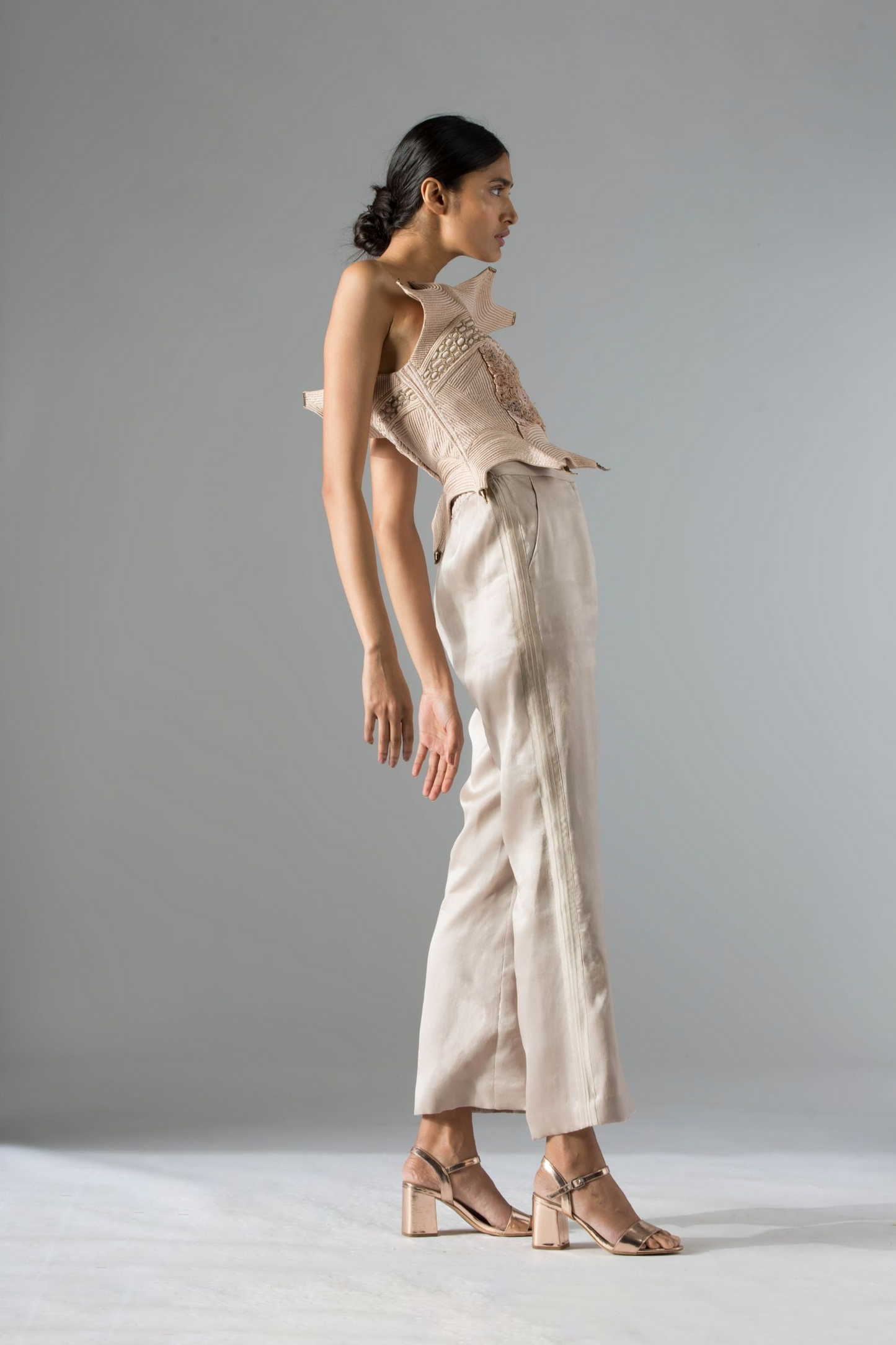 Side view of the Dune corset top, highlighting its tailored fit and intricate embroidery, creating a stylish and modern look