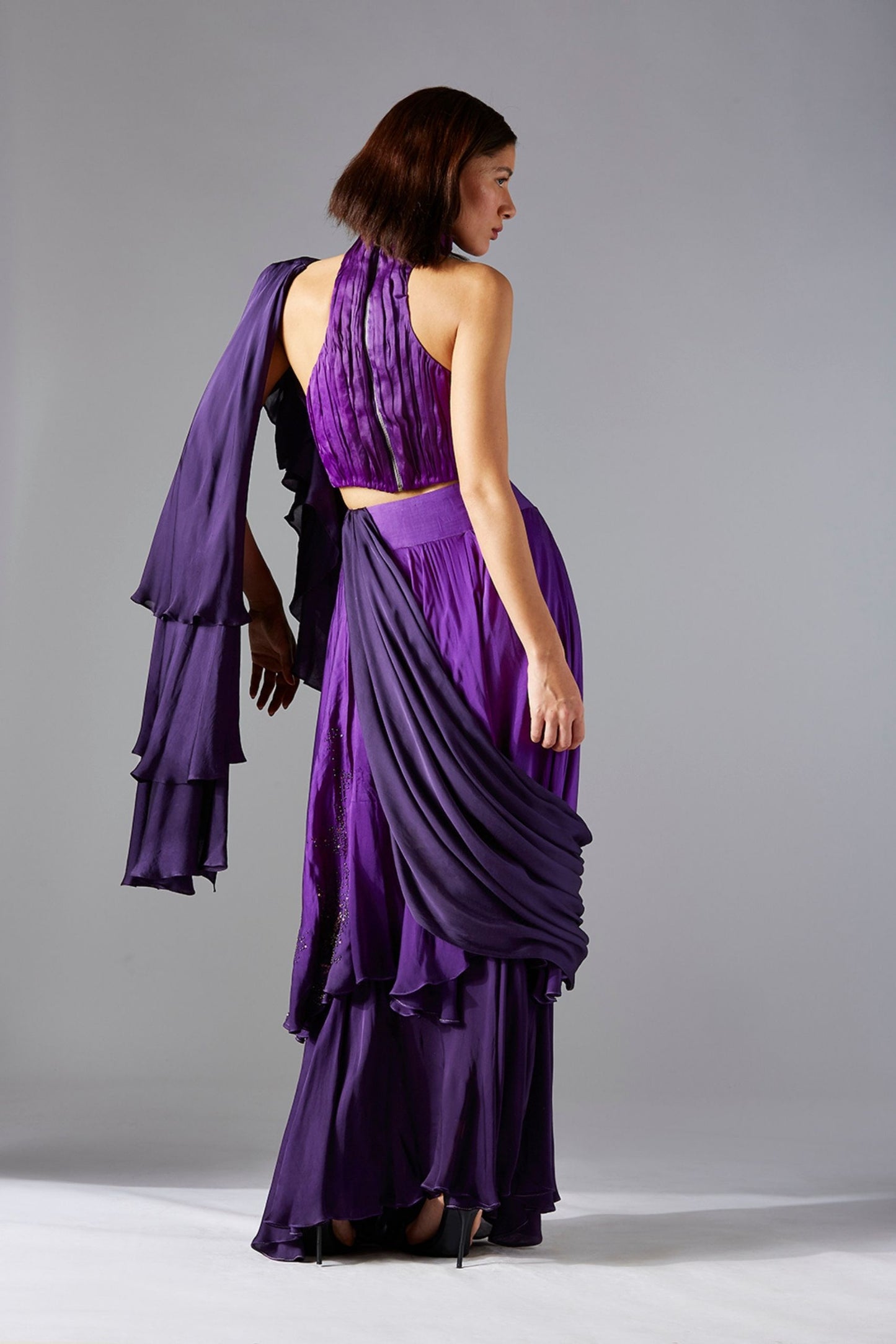 Back view of the crop top and layered skirt with dupatta, emphasizing the elegant flow and design