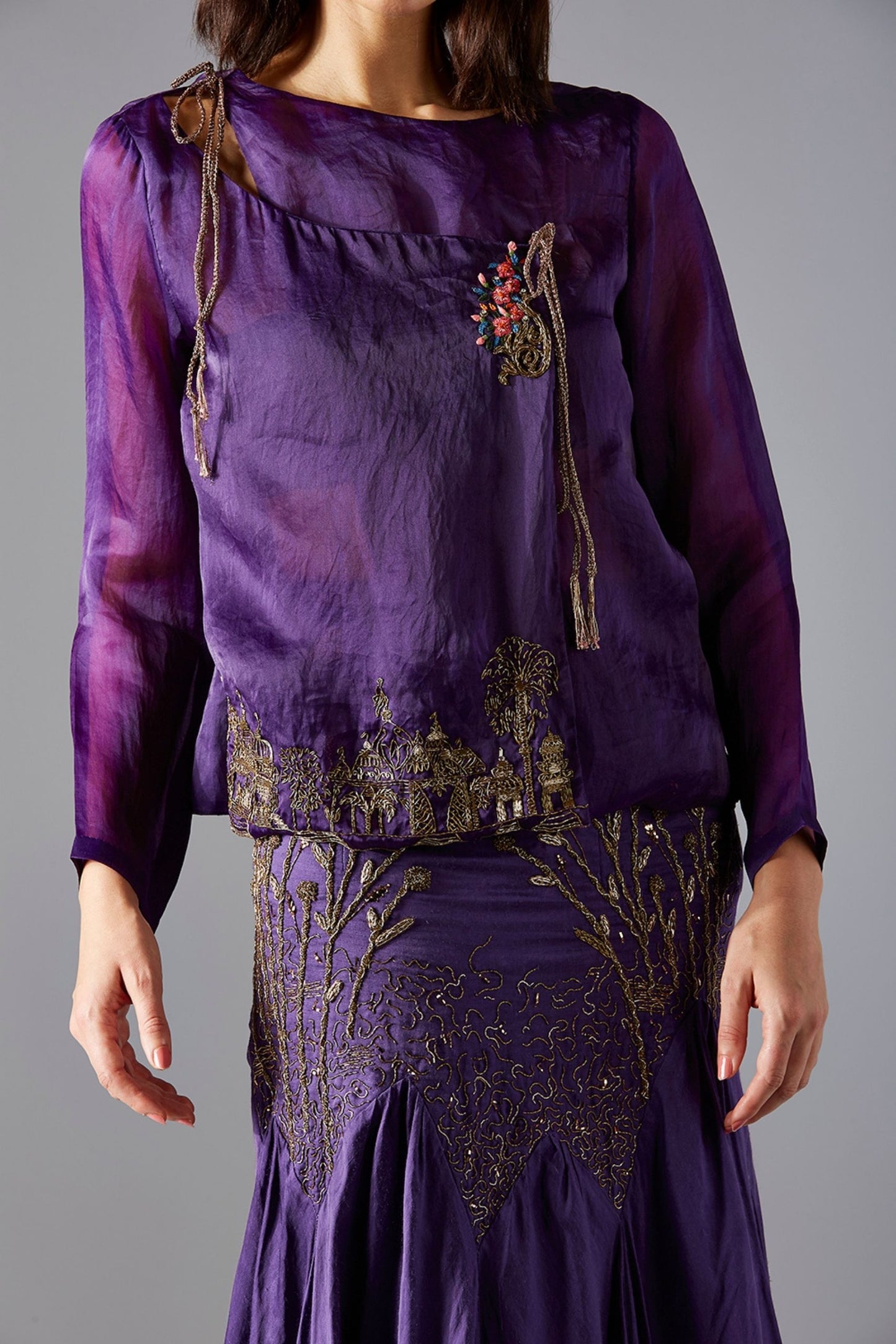 Focused view on the abstract embroidery on the corset top, paired with the vibrant batik fabric of the skirt