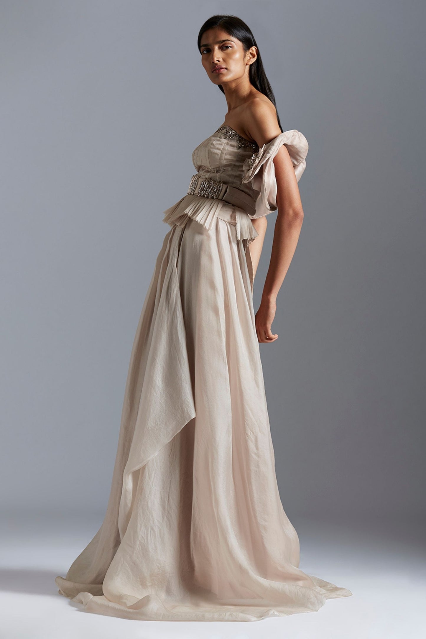 Side profile of a woman in the corset and skirt set, emphasizing the structured fit of the corset and flowing skirt