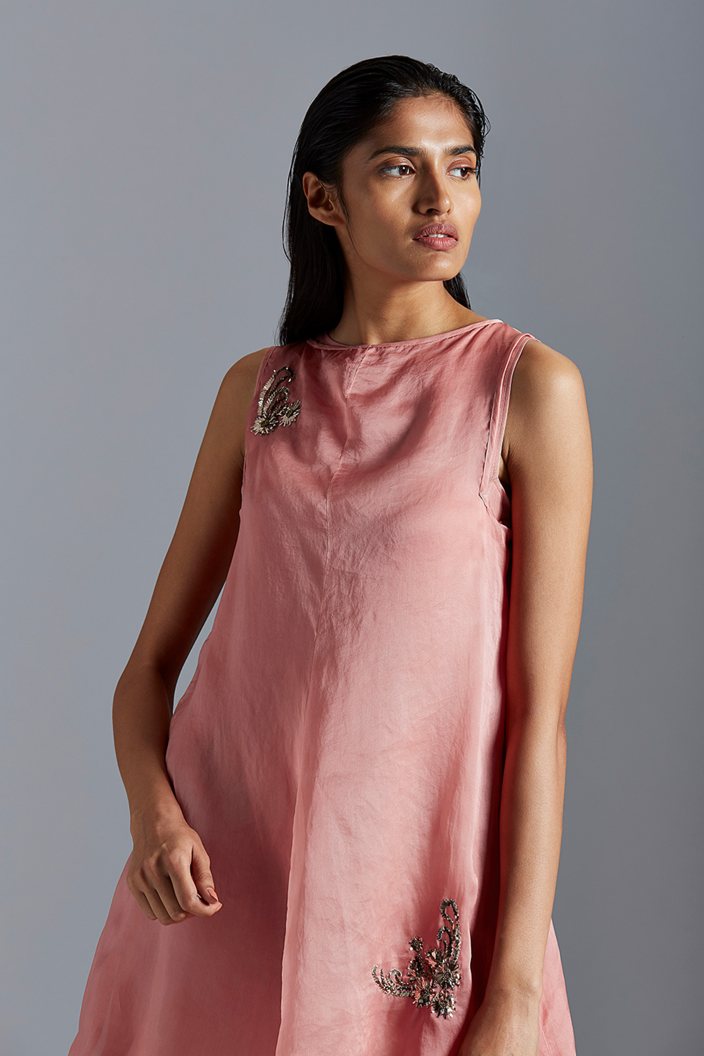 Model wearing the flamingo skirt suit, showcasing the beautiful mukaish and batik details in satin organza