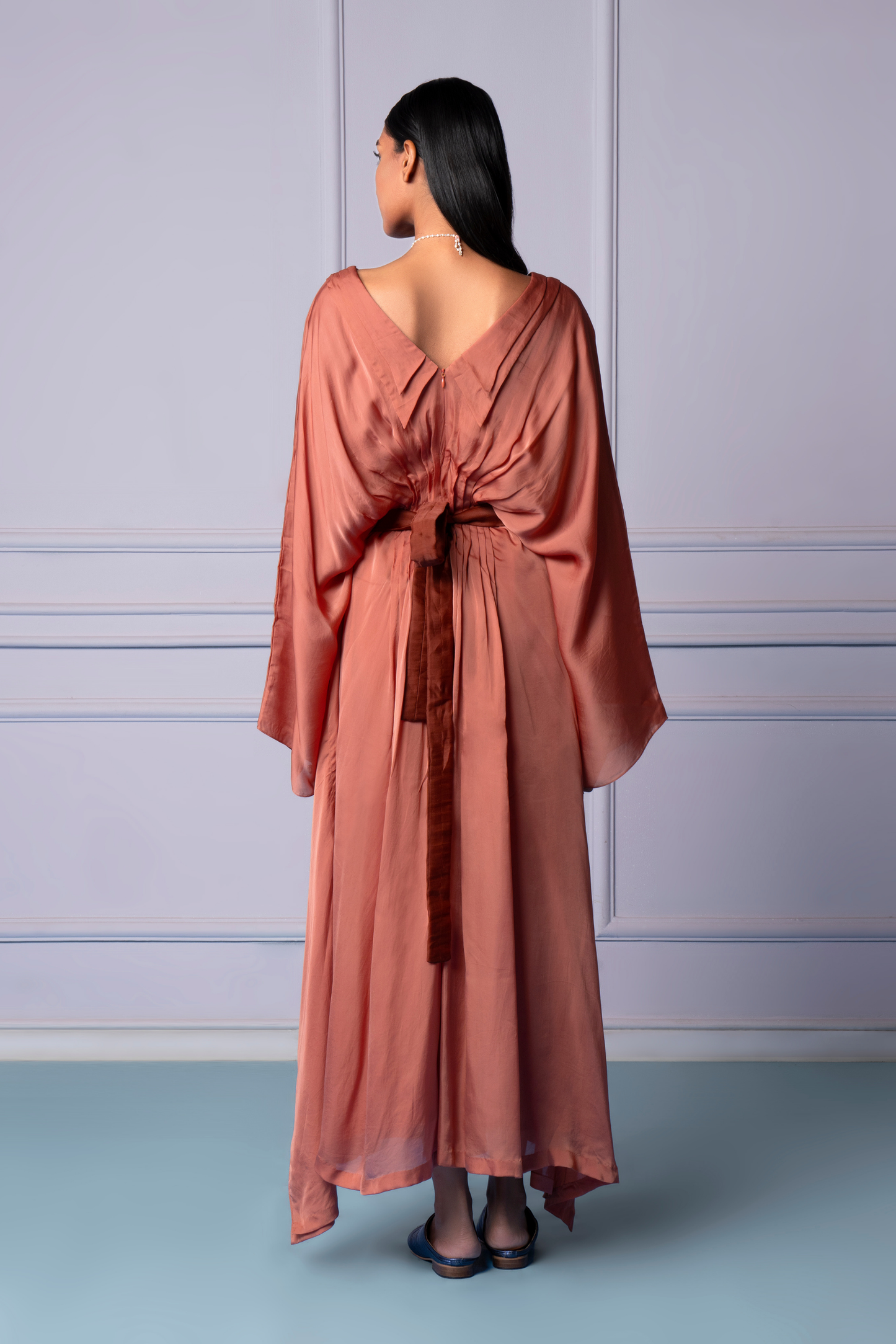 Back view of the double-collared kaftan dress, showing the elegant drape and embroidered belt that defines the modern look