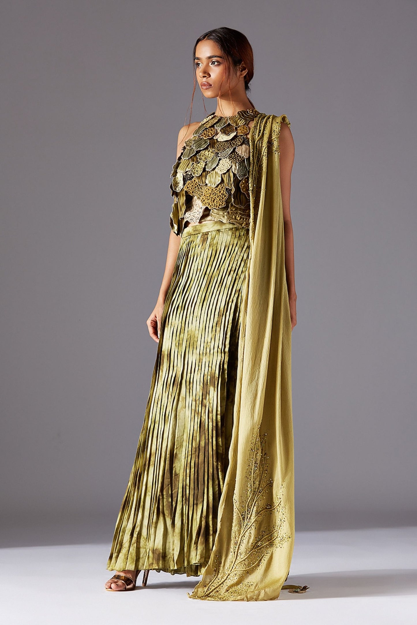 Designer top with couture details paired with a pleated skirt and embroidered dupatta for a chic and elegant look.