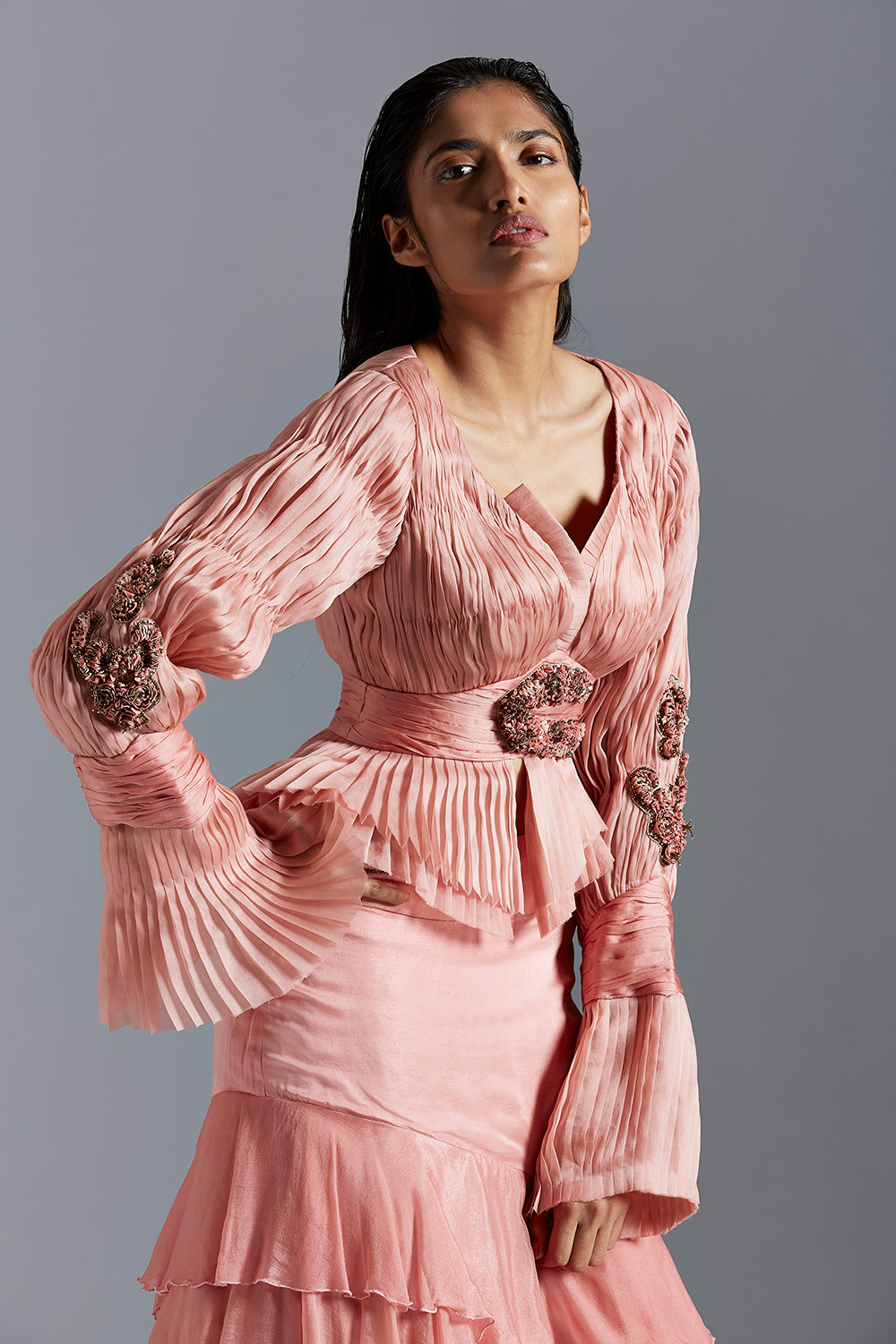 Close-up of the peplum top with Victorian sleeve detailing and the flow of the satin organza skirt