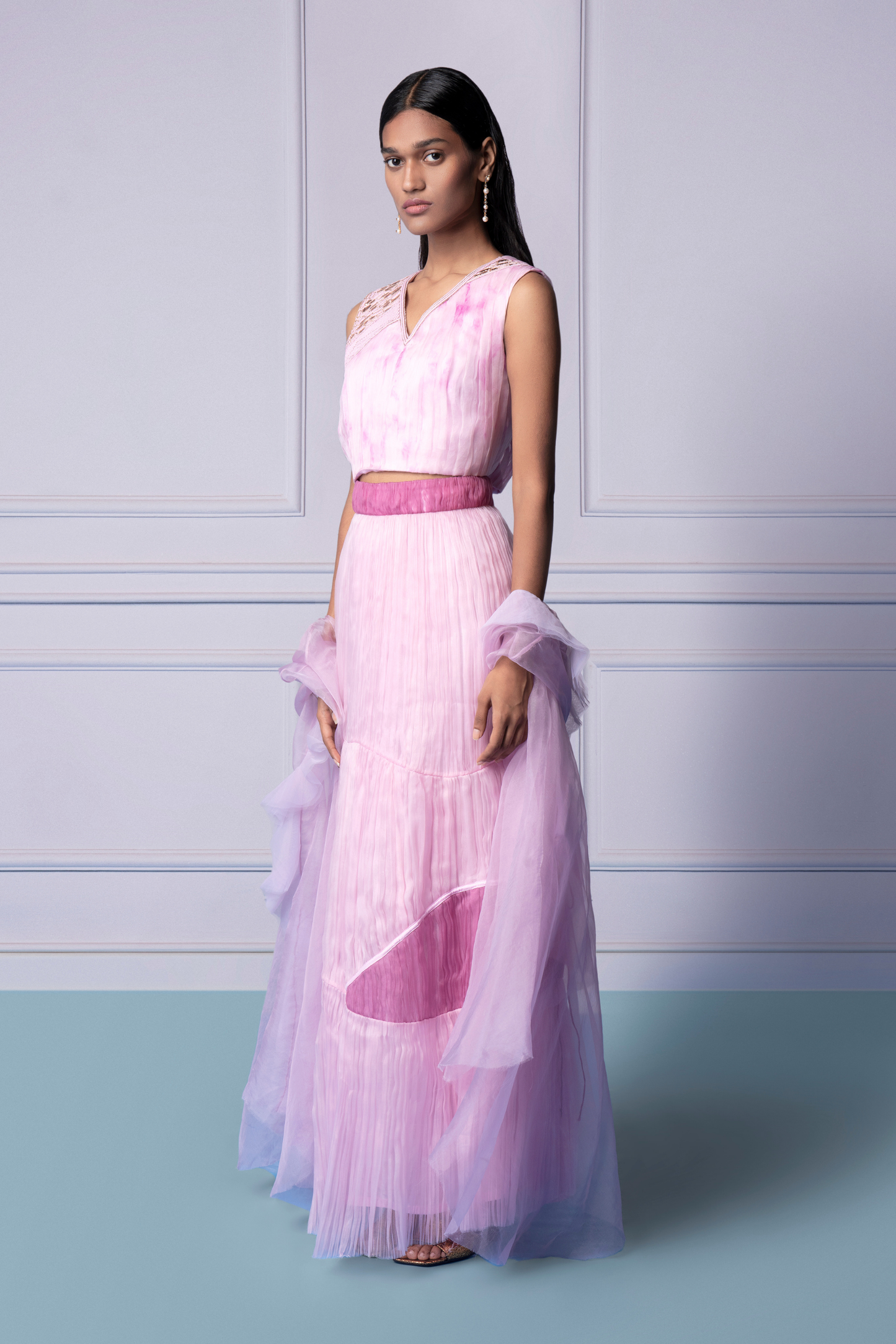 Side view of the Carnation lehenga set, emphasizing the flowy tiered skirt and beautiful mukaish embroidery