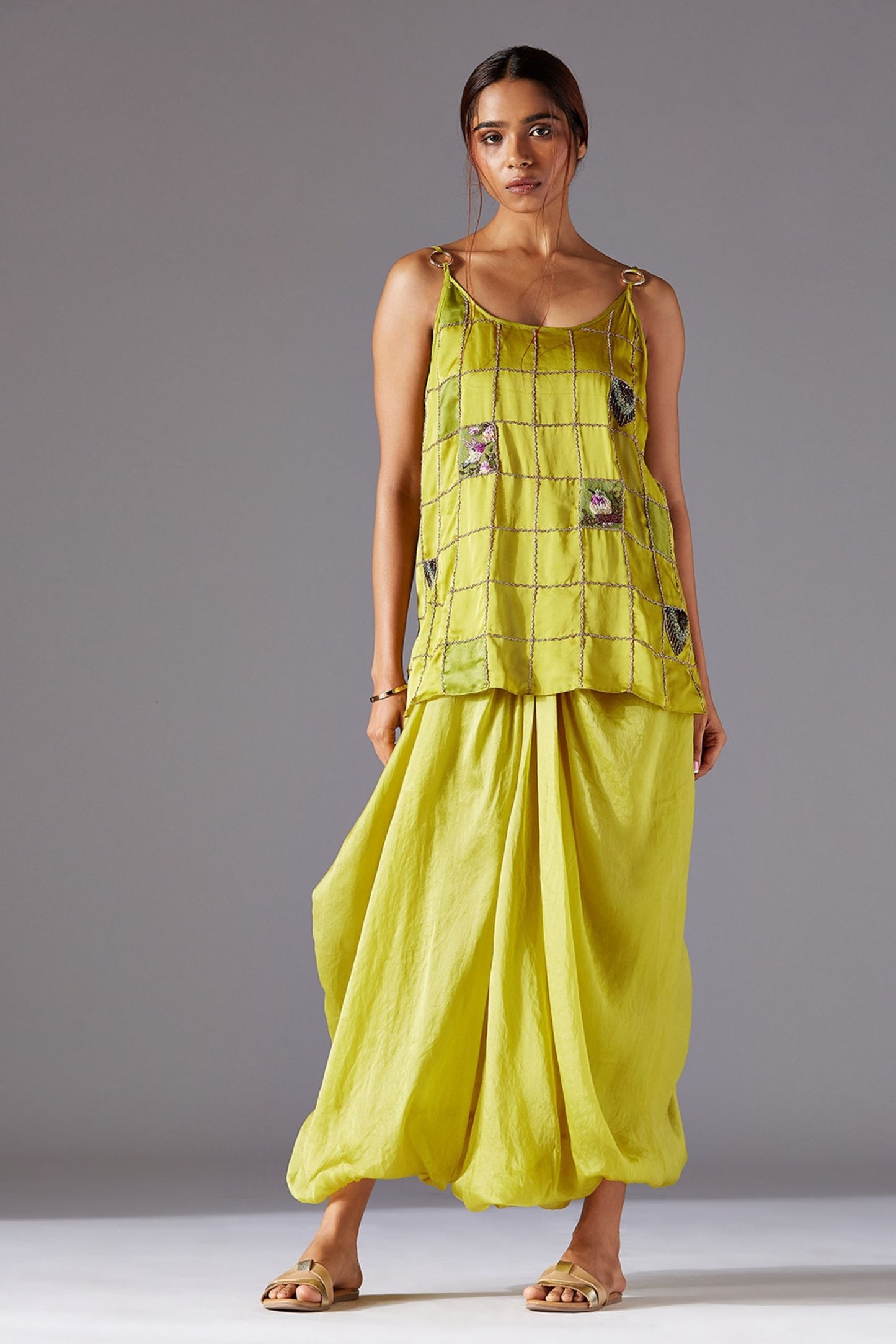 Designer spaghetti strap top paired with cowled harem pants, a modern pant and top set for women featuring handwork details