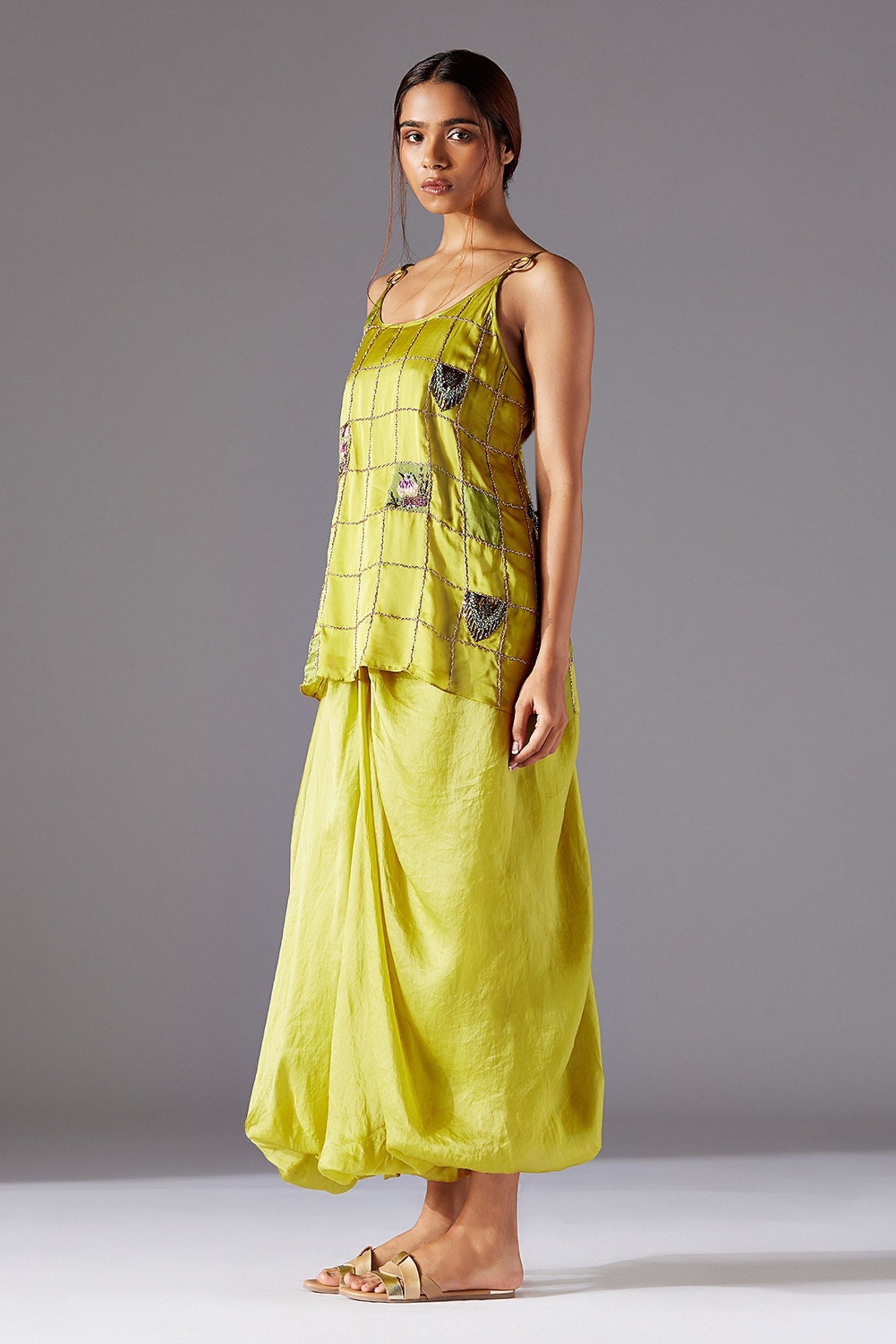 Side profile of the spaghetti top and cowled pants, emphasizing the elegant drape and modern silhouette