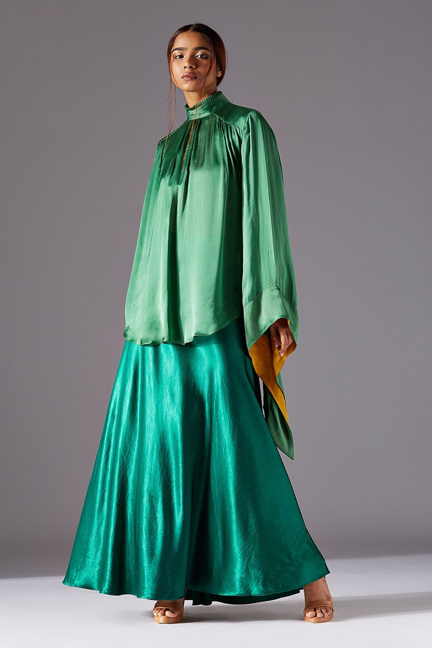 Ruffled high neck on the kimono shirt, highlighting the flowing silhouette of the long skirt