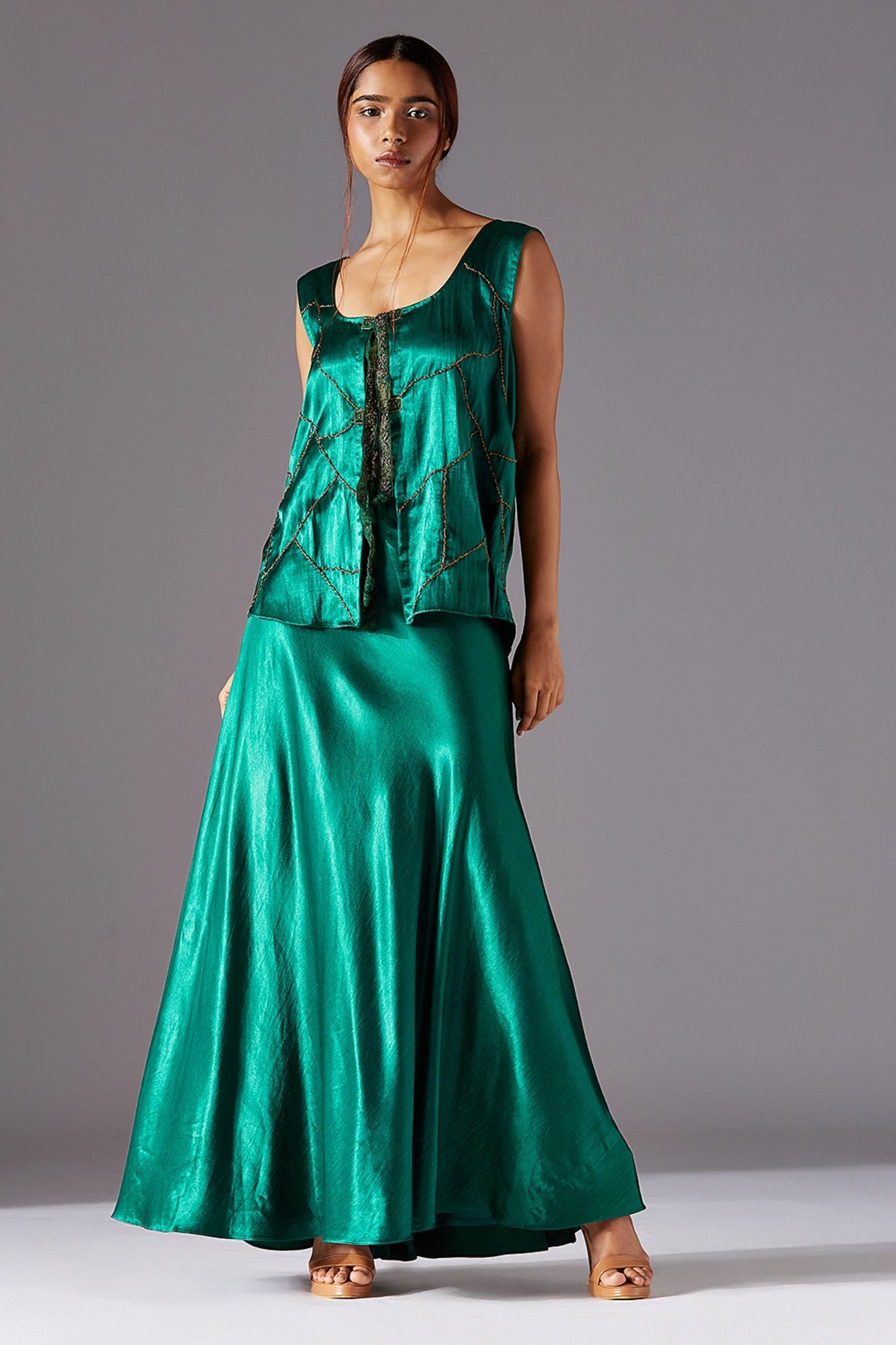 Sleeveless metallic tie-up jacket with a flared long skirt, showcasing a stylish jacket skirt set for women