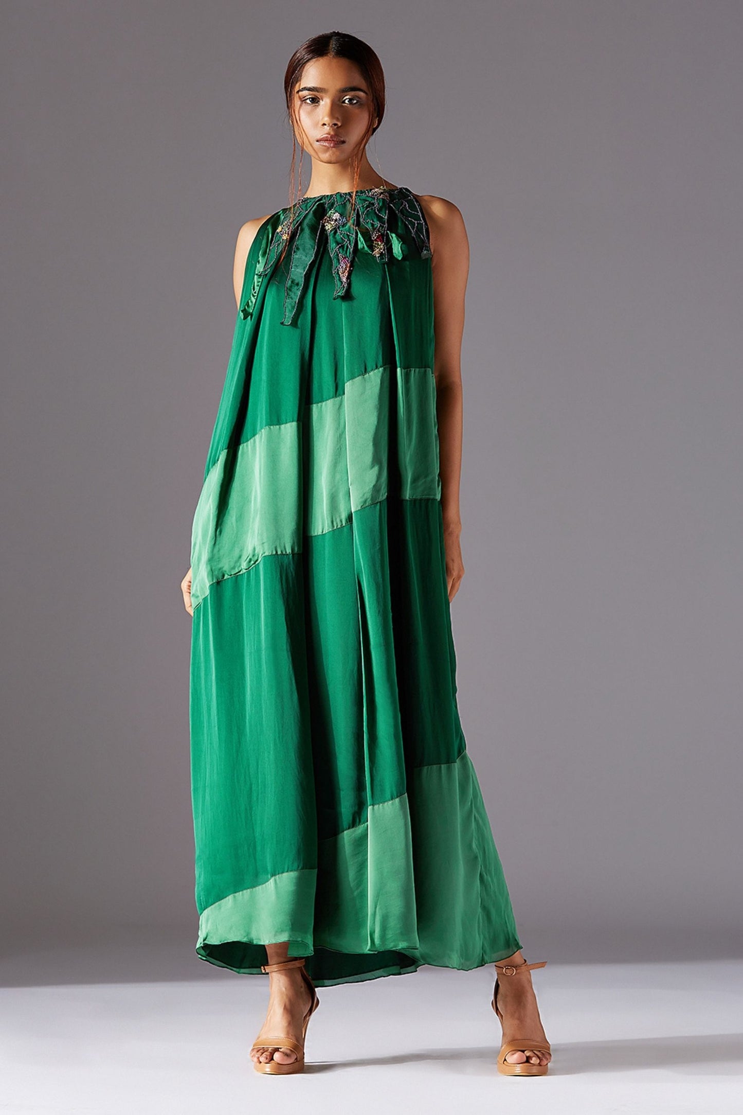 Full-length view of the Ridgescapes Triangle Dress, featuring ankle-length box pleats, triangular accents, and metallic handwork