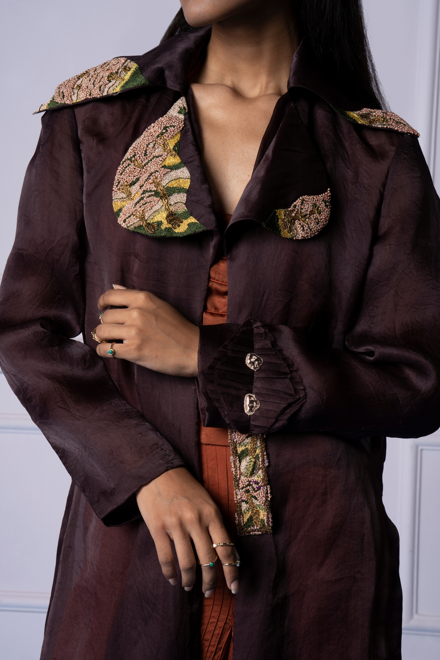 Focused view of the hand-embroidered French knots on the jacket, highlighting the fine stitching and luxurious design