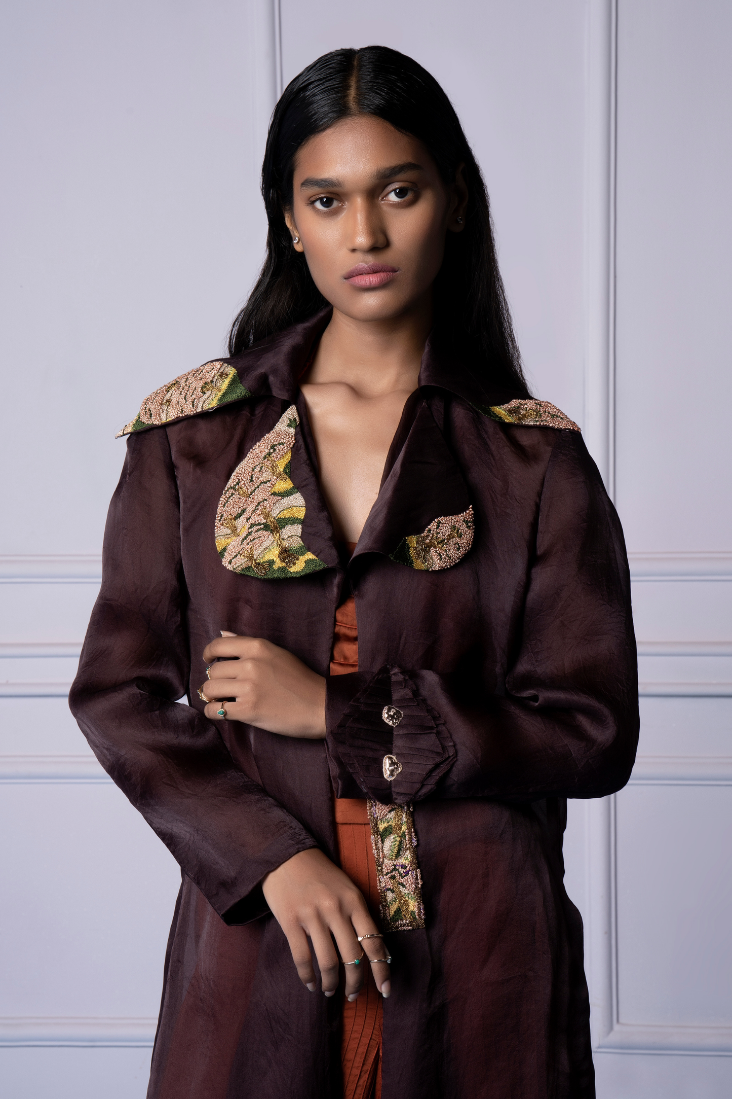 Close-up view of the hand-embroidered French knots on the Carpet Jacket, showcasing intricate details and craftsmanship