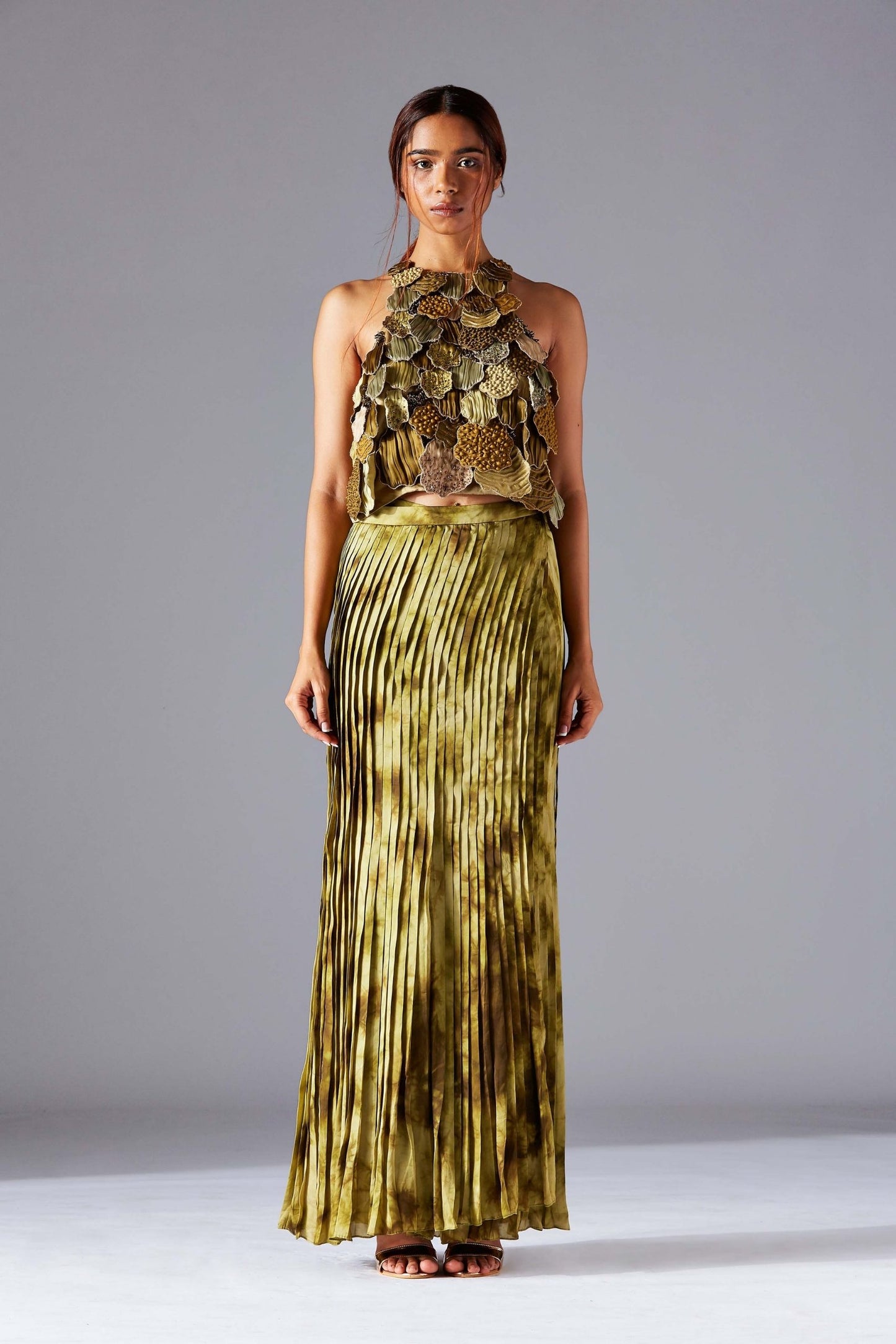 Designer top with intricate leaf handwork paired with a pleated wrap skirt for women, styled for a chic and contemporary look