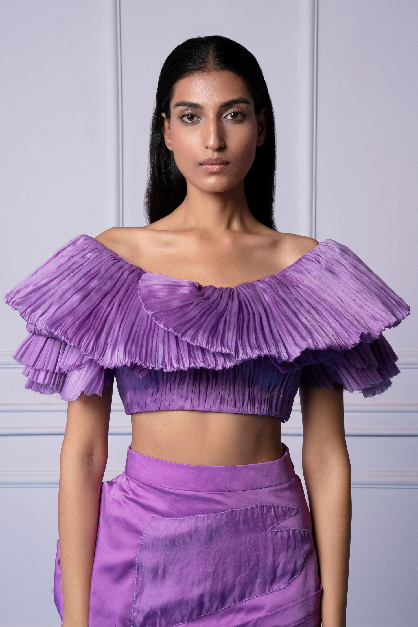 Close-up view of the rose embellishments on the skirt and the elegant design of the crop top