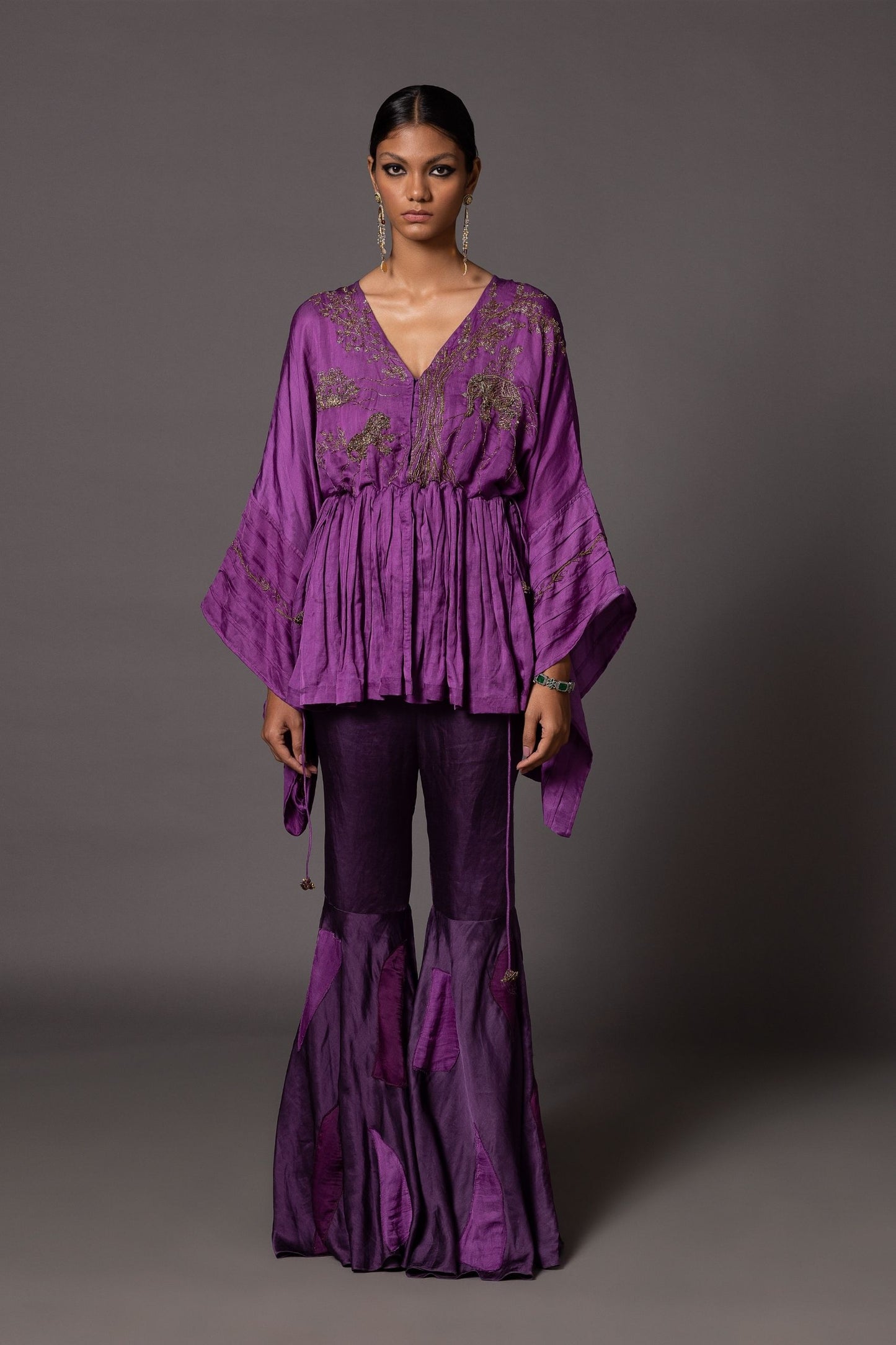 Shikhar Baugh purple peplum top with metallic Jaipur motifs, paired with fit-and-flare gharara pants with color-blocked patchwork