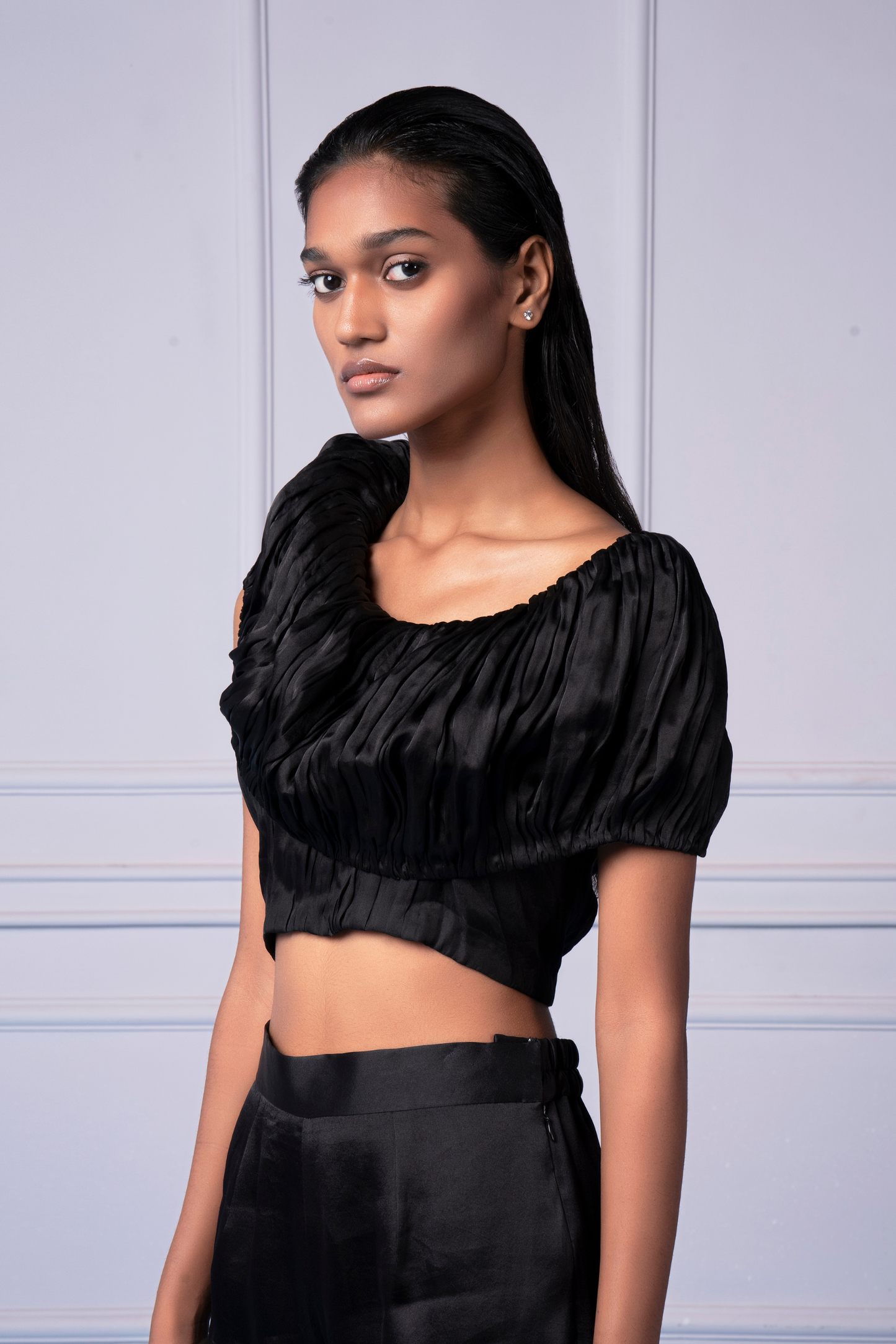 Focused image highlighting the intricate hand-ruched satin detailing on the crop top