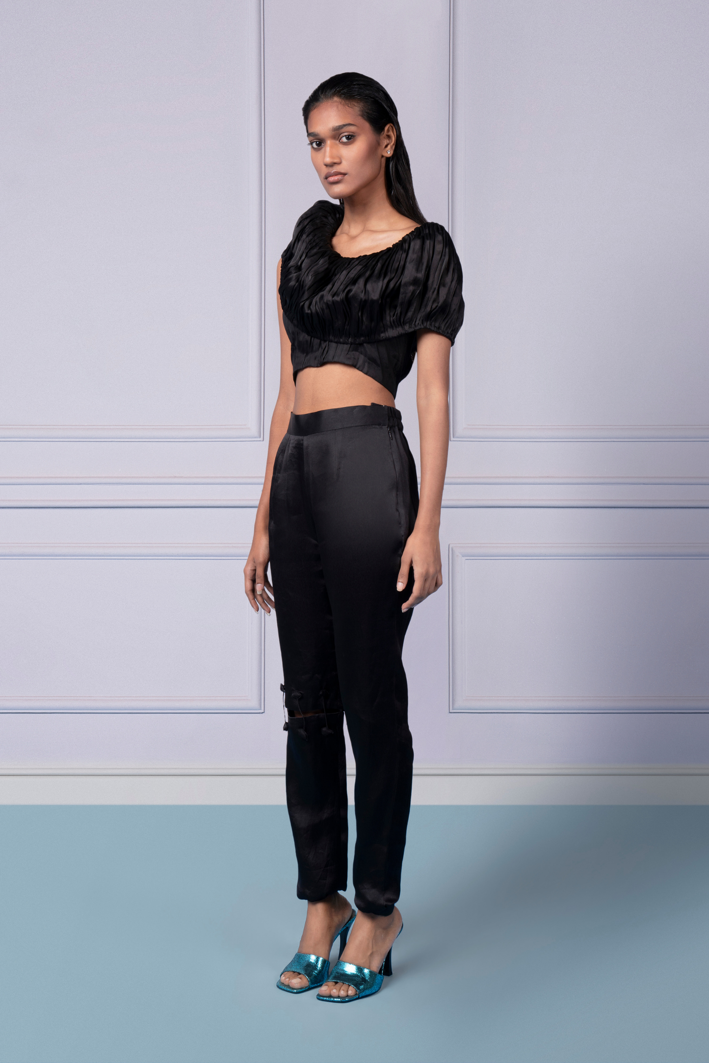 Black crop top and chic cut-out pants set for women, styled together