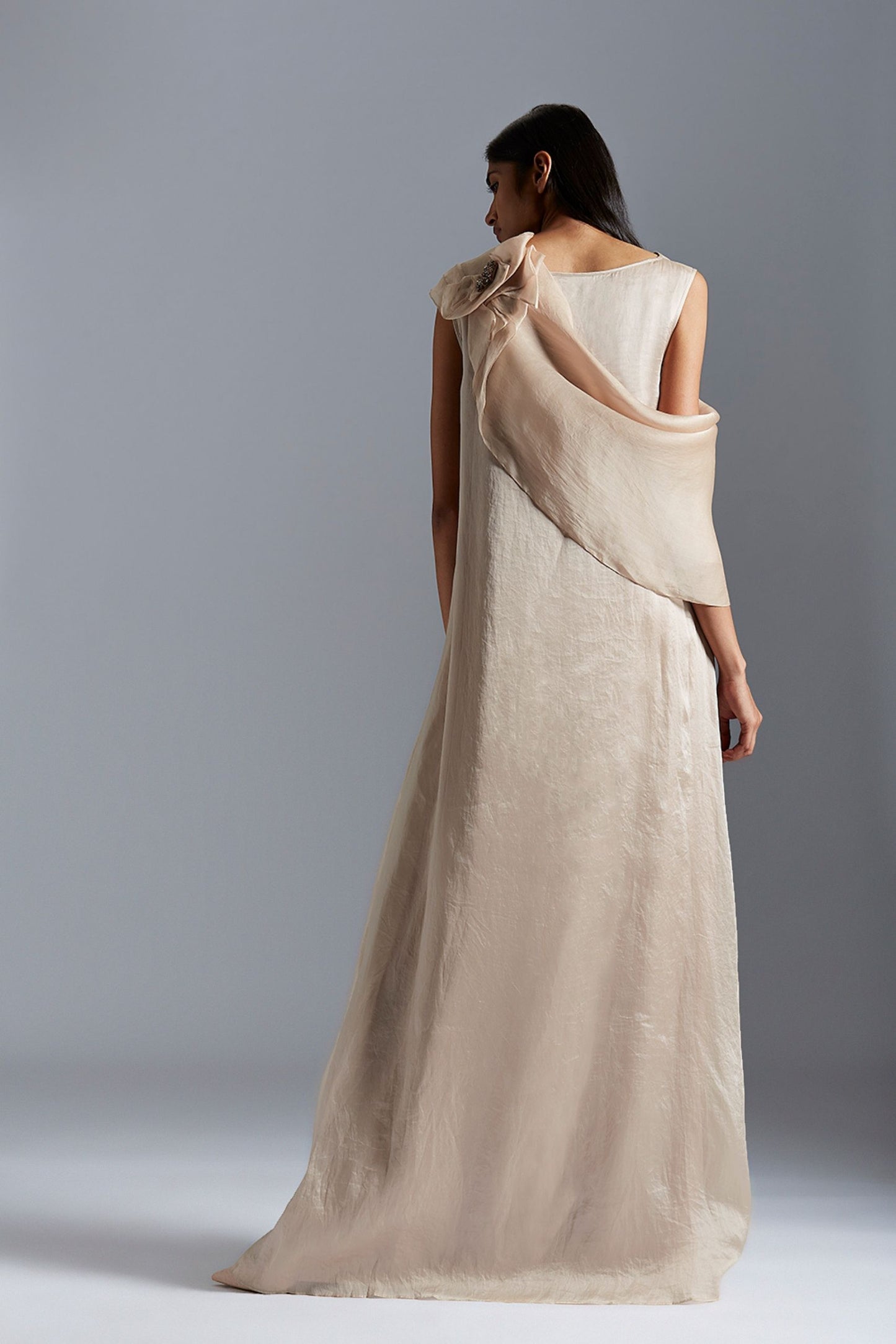 Back view of the A-line gown with beaded cape, highlighting the graceful flow and detailed Mukaish embroidery