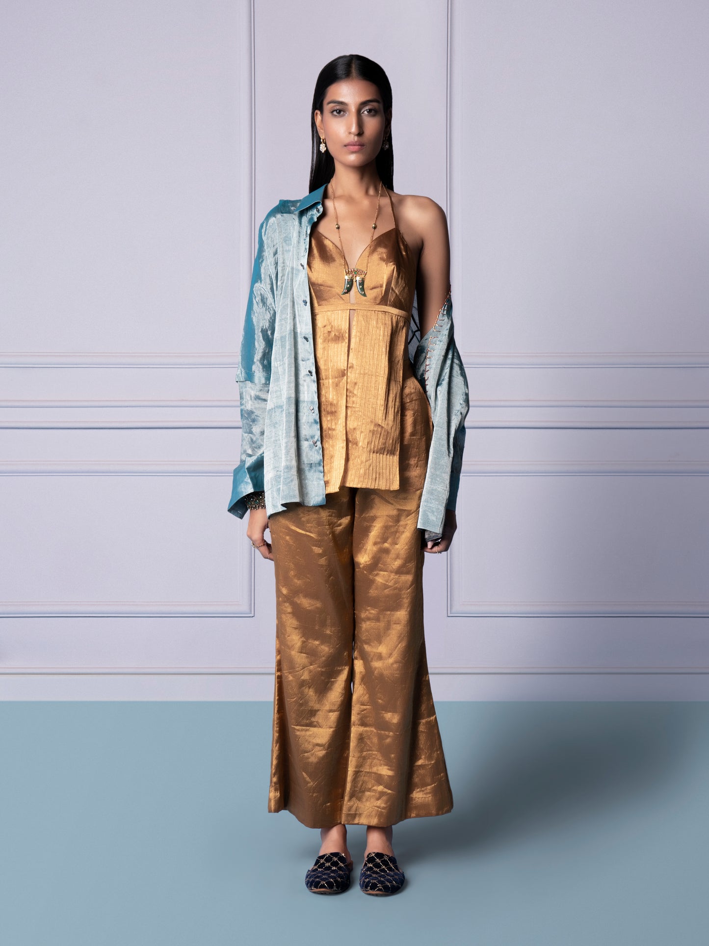 Gold Chanderi bralette, trousers, and blue shirt set for women, showcasing a stylish and luxurious look