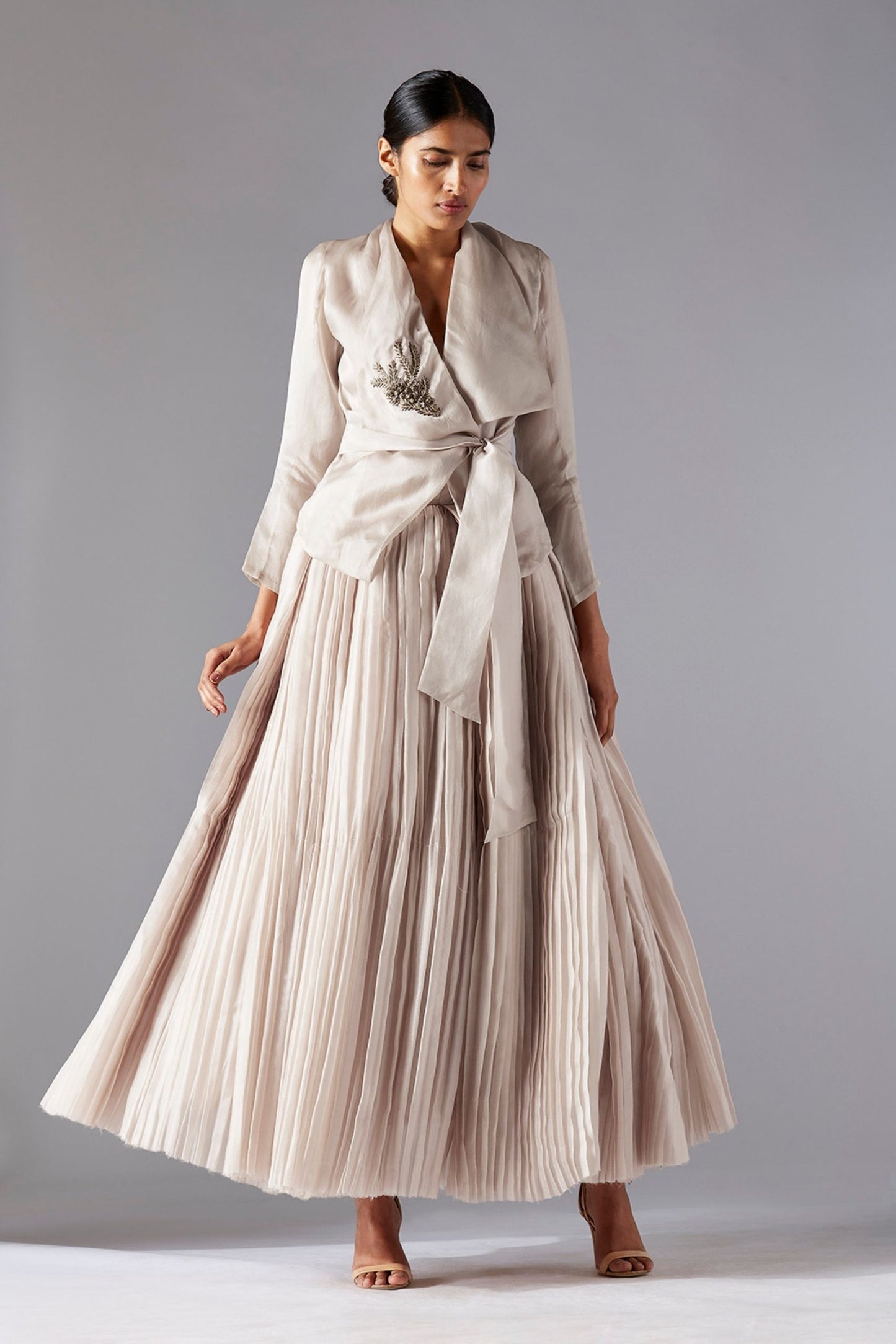 Designer sheer organza jacket with 3D metallic work paired with a pleated ballroom skirt, offering a stylish and elegant look for women