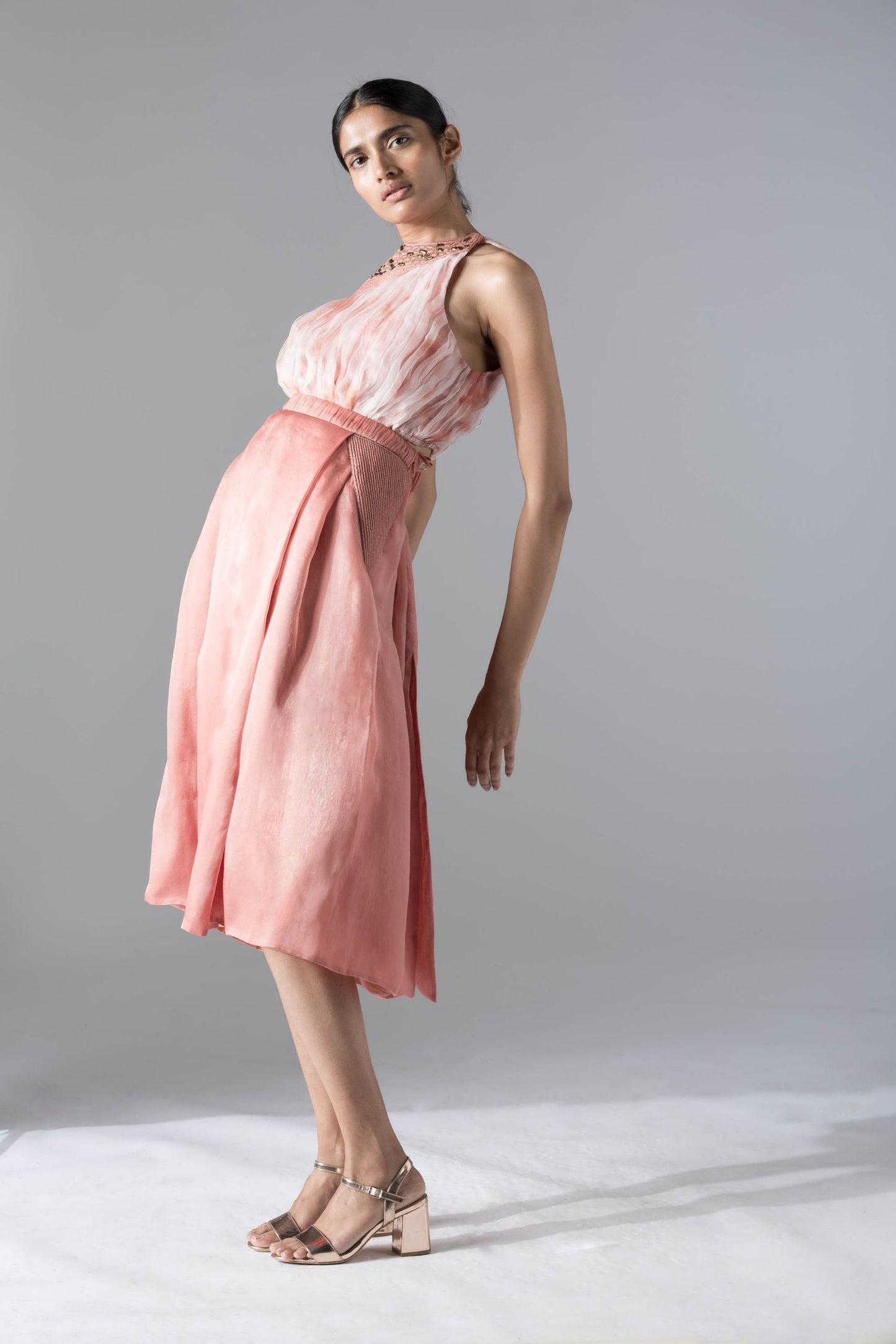 Full view of the top skirt set for women, showcasing the batik-dyed rouched crop top and pleated pant skirt with rope inlayed details