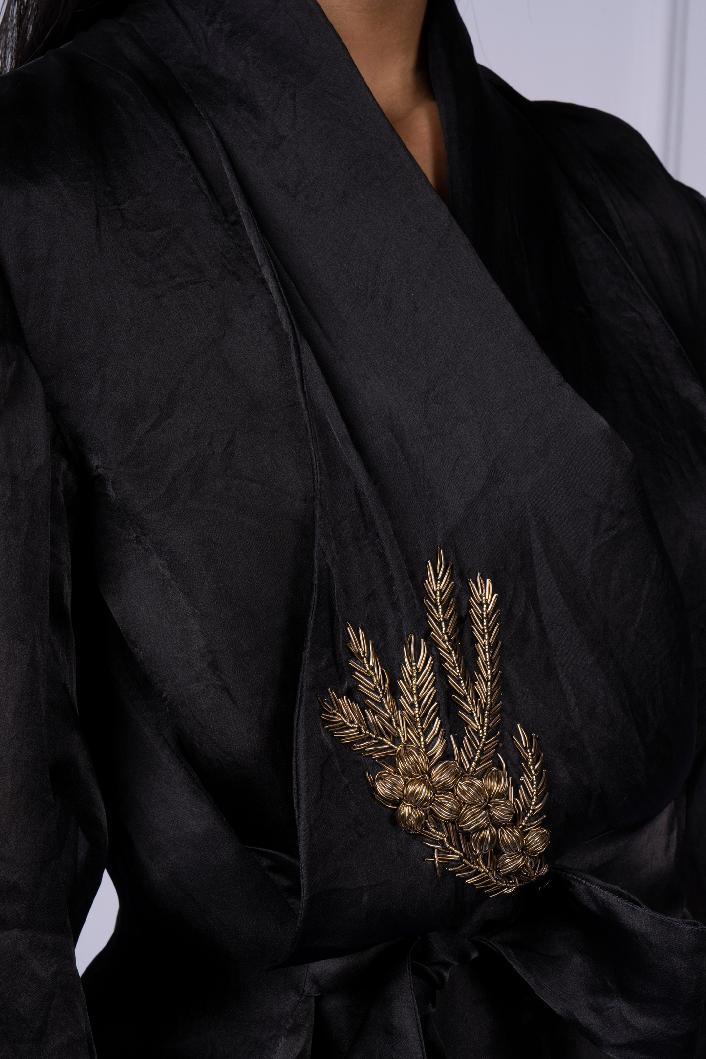 Close-up of the embellishments on the wrap organza jacket, showcasing the intricate design and luxurious detailing