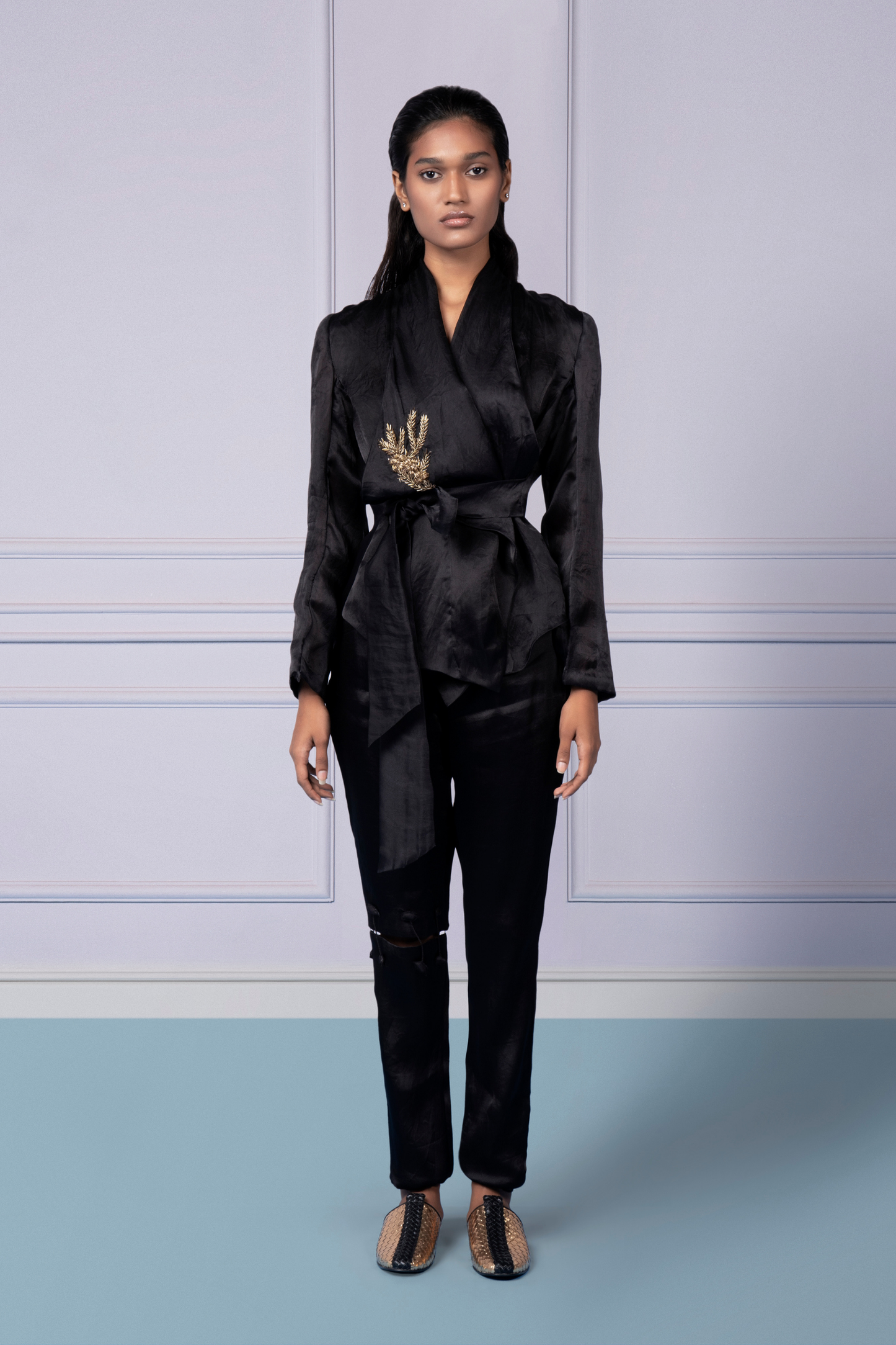 Stylish wrap organza jacket with embellishments and narrow pants with knee cutouts, perfect for modern women’s fashion