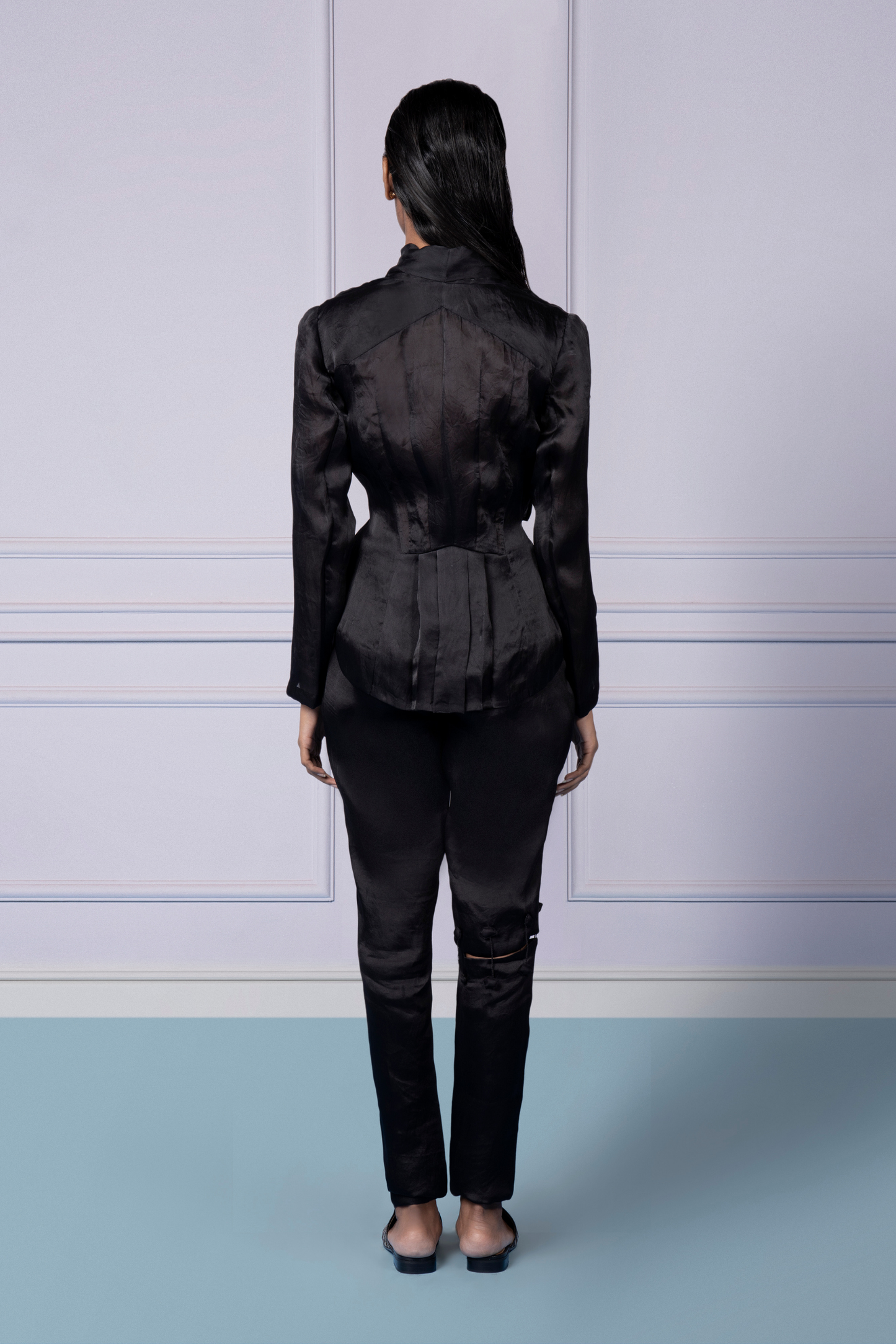 Back view of the wrap organza jacket and narrow pants, showcasing the elegant design and tailored silhouette