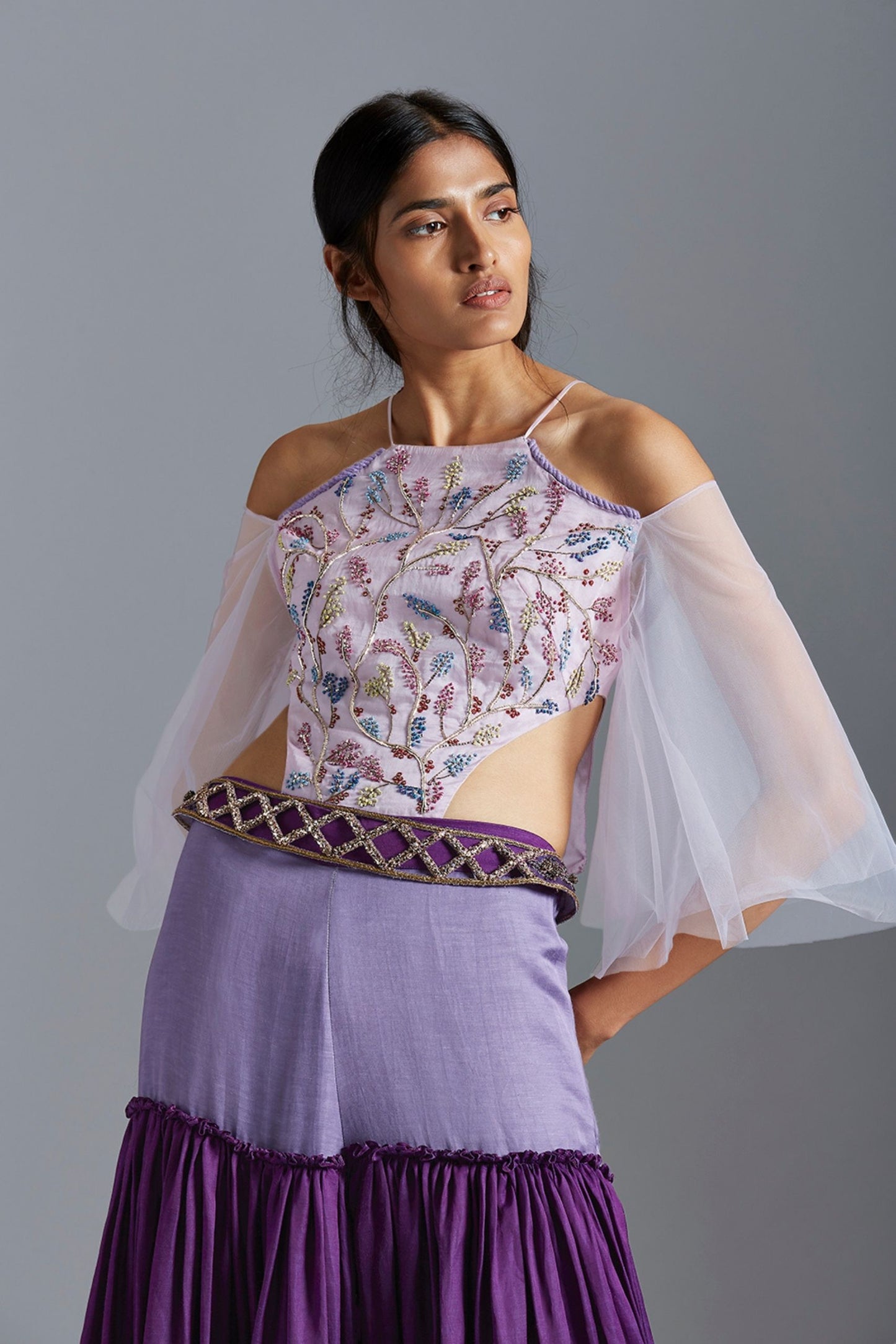 Close-up of the French knot embroidery on the bodysuit blouse, highlighting the intricate details of the design