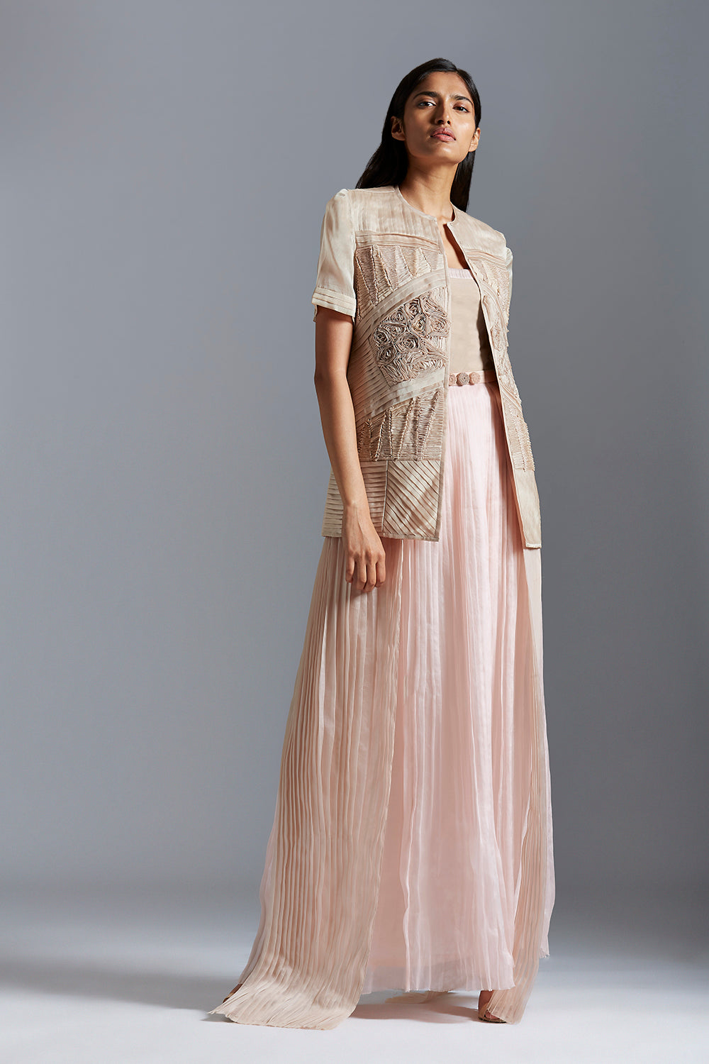 Designer sheer jacket with fabric details paired with a pleated tube dress for women, offering a stylish and modern look
