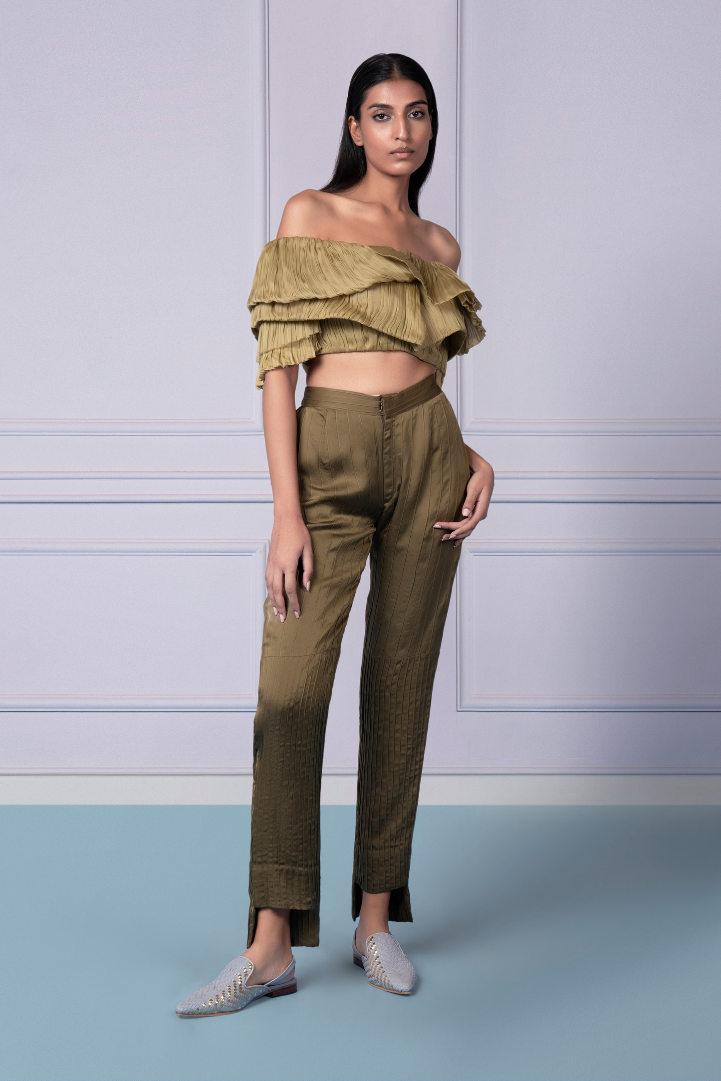 Woman confidently styling the Gill Fungi crop top and pintuck pants, ideal for fashion-forward looks