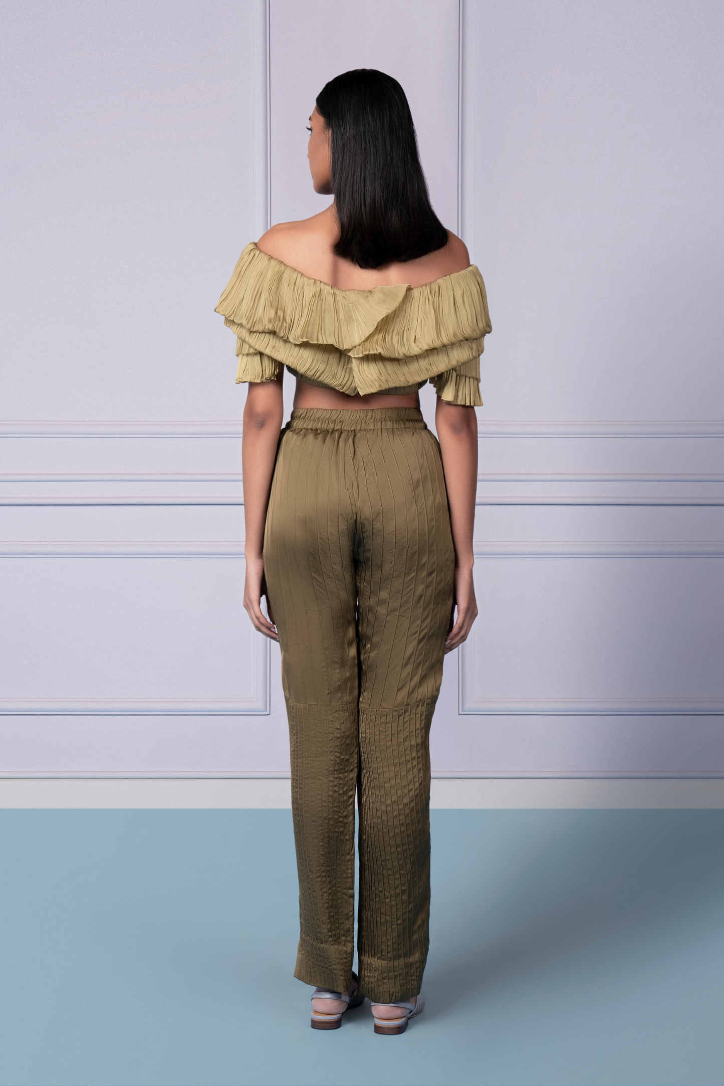 Back view of the Gill Fungi off-shoulder crop top and pintuck pants, emphasizing the chic design