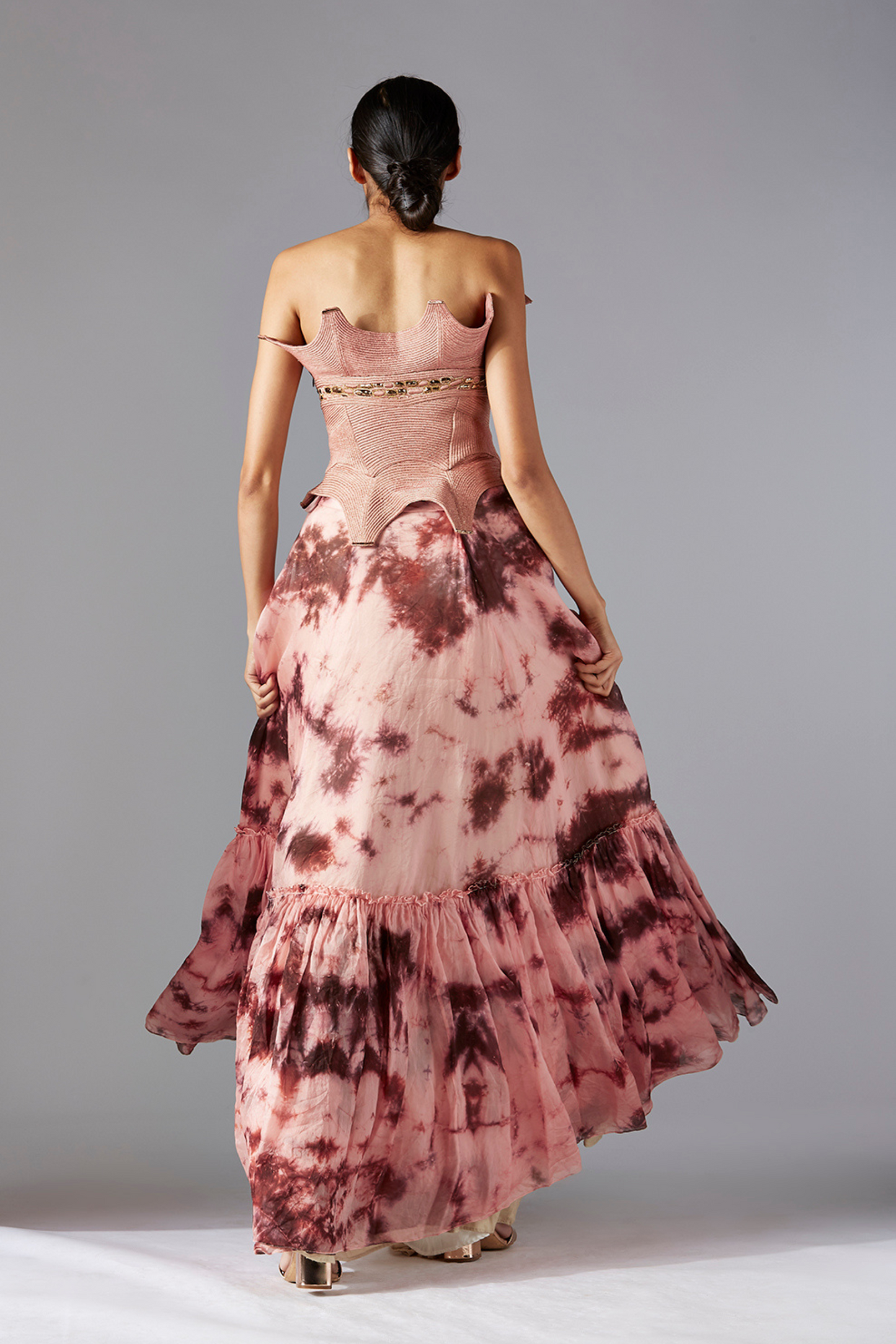 Back view of the corset and skirt set, highlighting the corset fit and the elegant flared batik skirt