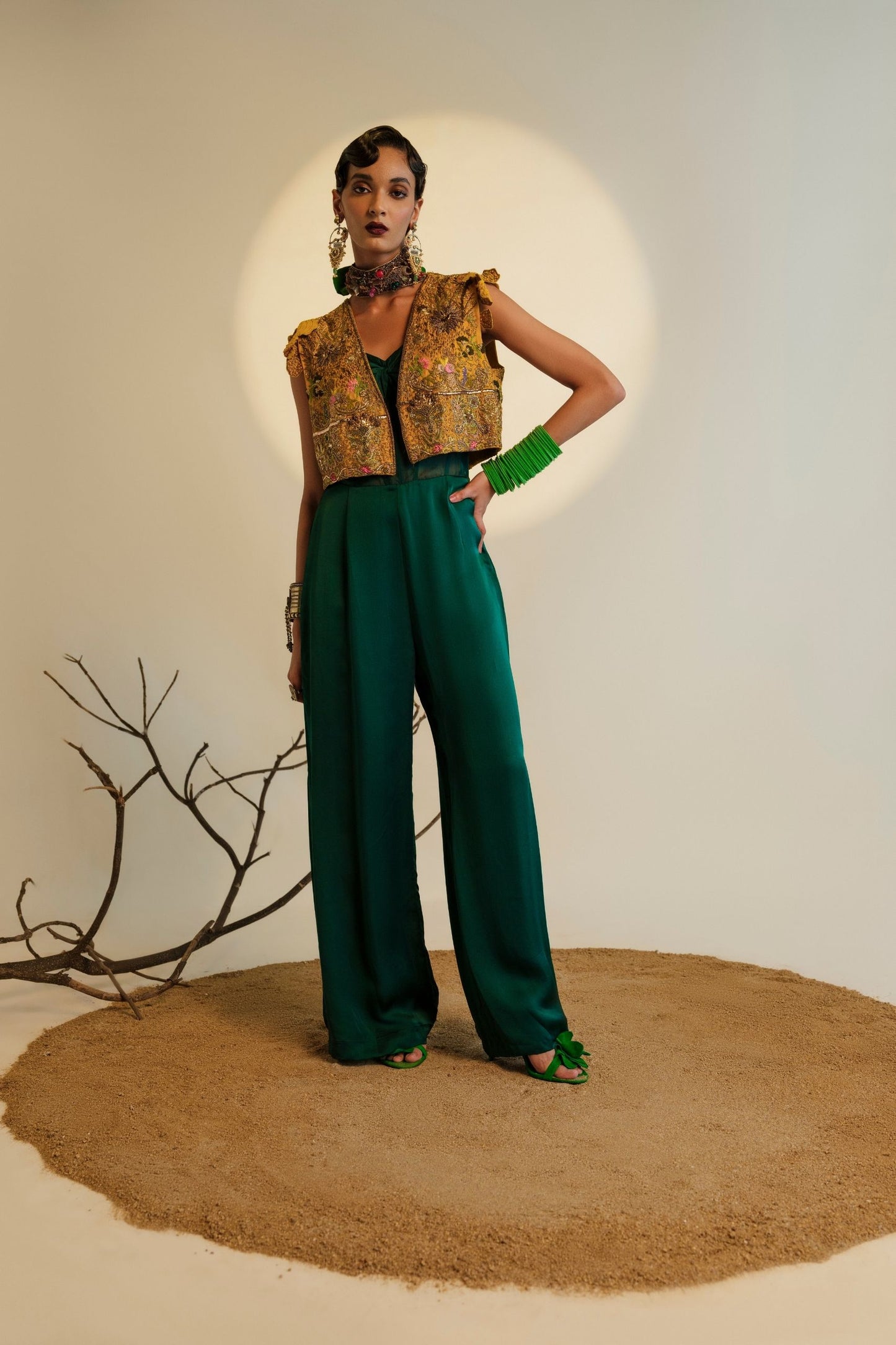Namib Bottle Green Women's Jumpsuit with knotted bodice and sheer corset, paired with Paro Cropped Embroidered Jacket featuring exquisite Zardosi handwork