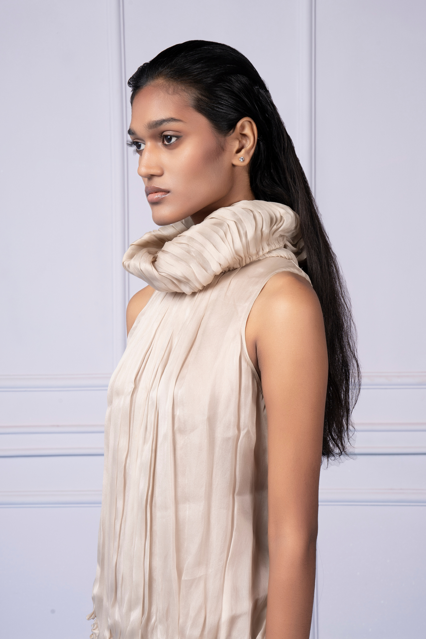 Side profile of a woman in the Wind Waft dress, highlighting the elegant fit and fabric sculpting