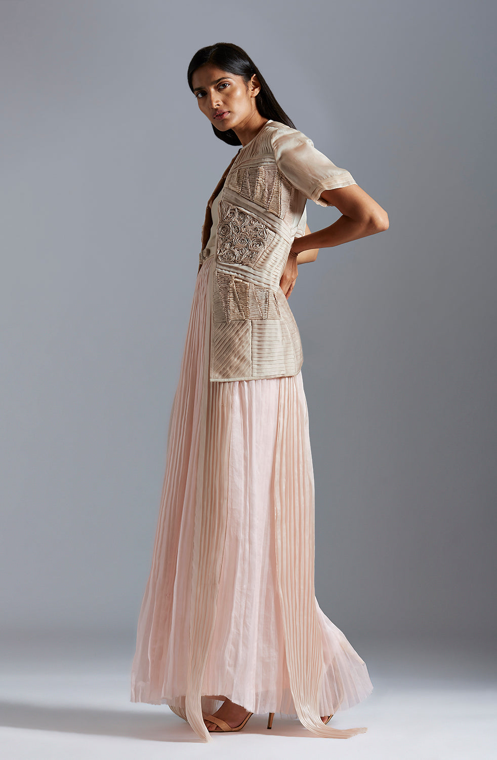 Side profile of a woman in the designer sheer jacket and tube dress, highlighting the modern, flattering fit