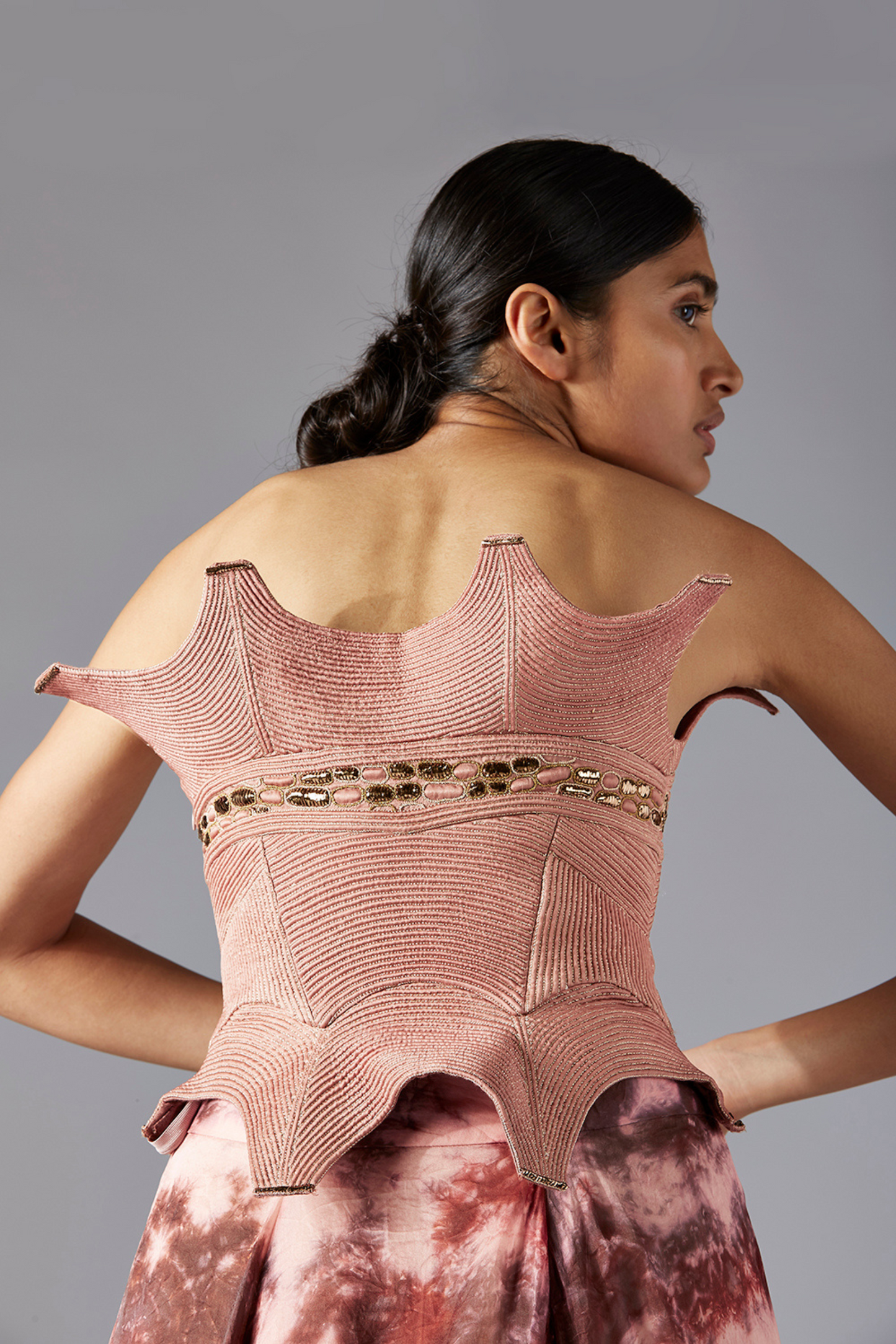 Back view of the corset top with inlaid dori work, showcasing the intricate design and fitted structure of the corset